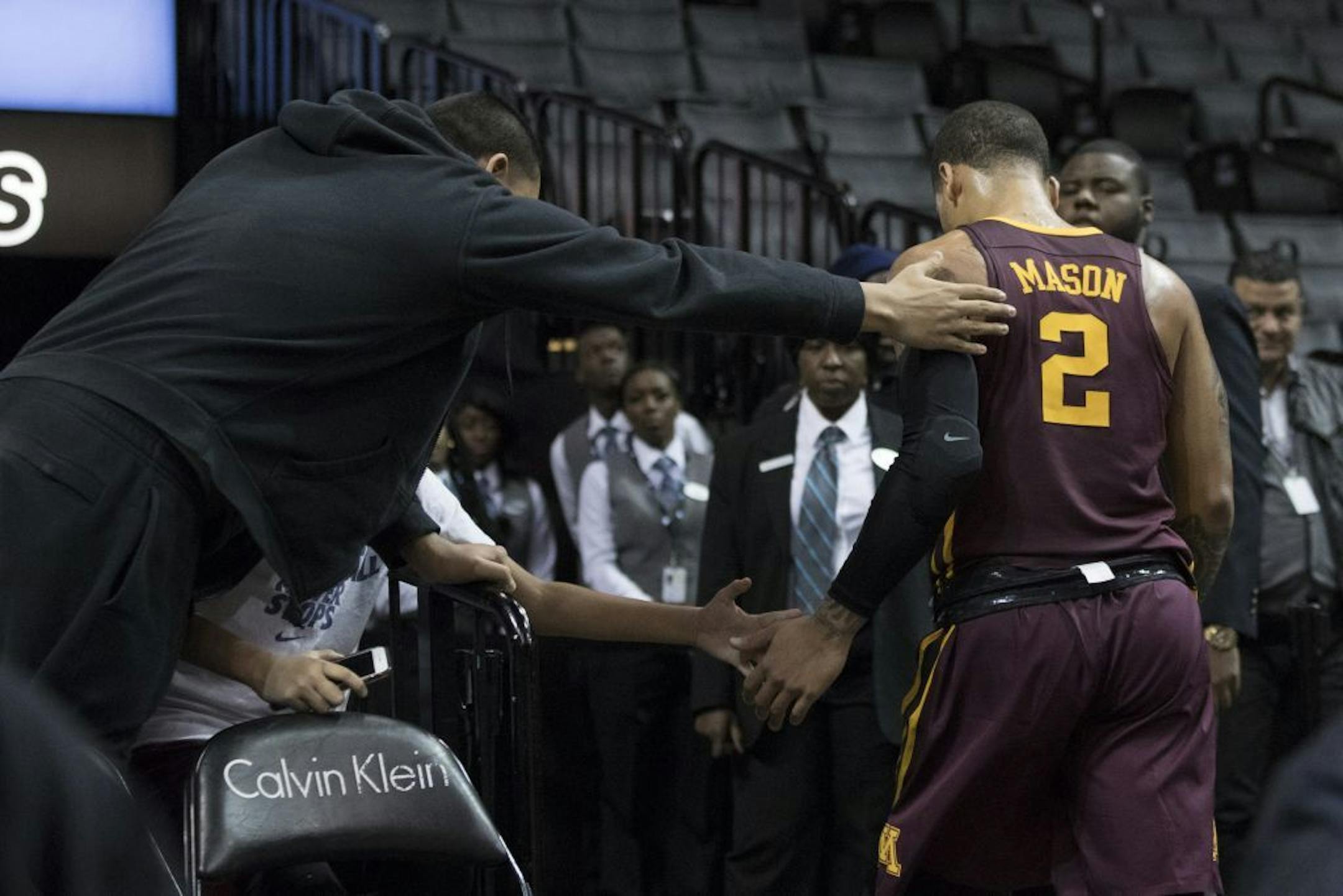 Nate Mason leaves the court after being ejected during the second half of an NCAA college basketball game, Saturday, Nov. 25, 2017, in New York. Minnesota won 89-84.