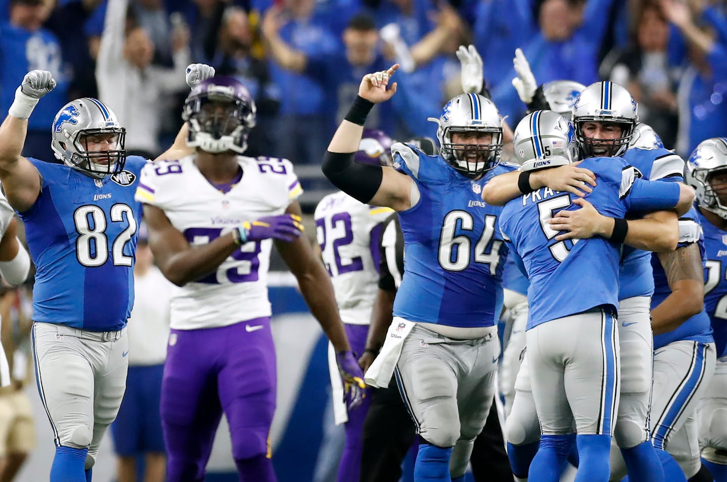 Vikings cornerback Xavier Rhodes walked the field as Lions kicker Matt Prater (5) celebrated his winning field goal Thursday afternoon.