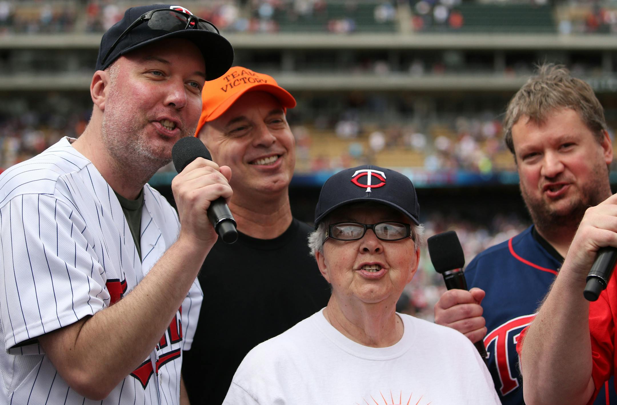 Chris Anderson, left, sang Take Me Out to the Ball Game along side, from left, his brother Tracy Anderson, mother Cathy Anderson, and longtime friend Mike Siebenaler, during the seventh inning stretch Saturday. ] ANTHONY SOUFFLE ï anthony.souffle@startribune.com Chris Anderson of Shakopee has multiple sclerosis and has become a positive force advocating for those with the disease. For Saturday's MS charity day at the Twins game he was chosen to sing Take me out to the ball game.