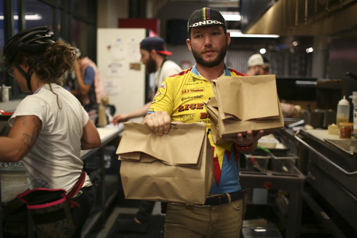 Jeff O'Neill carried three orders for delivery out of the kitchen at Taco Cat in the Midtown Global Market in Minneapolis Thursday night. ] JEFF WHEELER • jeff.wheeler@startribune.com Digital document delivery hasn't completely eliminated the career of the bike messenger, but the numbers of people making a living at it are fewer. Jeff O'Neill is one of three bike messengers working for Metro Legal Services in downtown Minneapolis. He was photographed Thursday evening, August 20, 2015 delivering