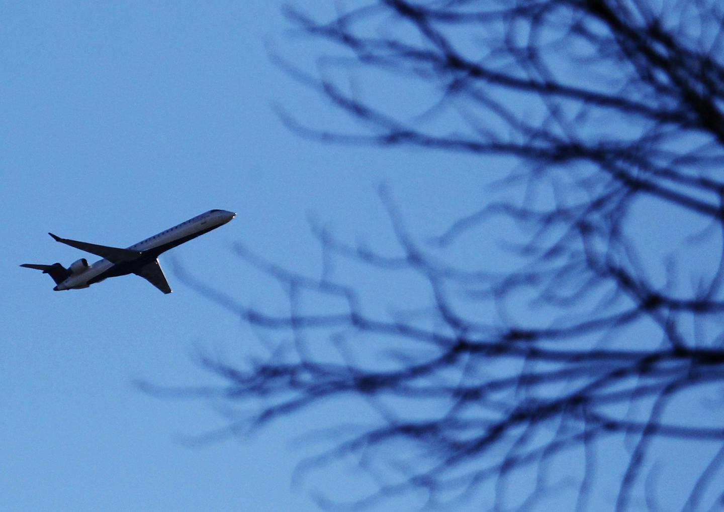 A plane that took off from MSP cruises over a Southwest Minneapolis neighborhood near the Crosstown and Oliver Ave. S Wednesday, Oct. 31, 2012, in Min