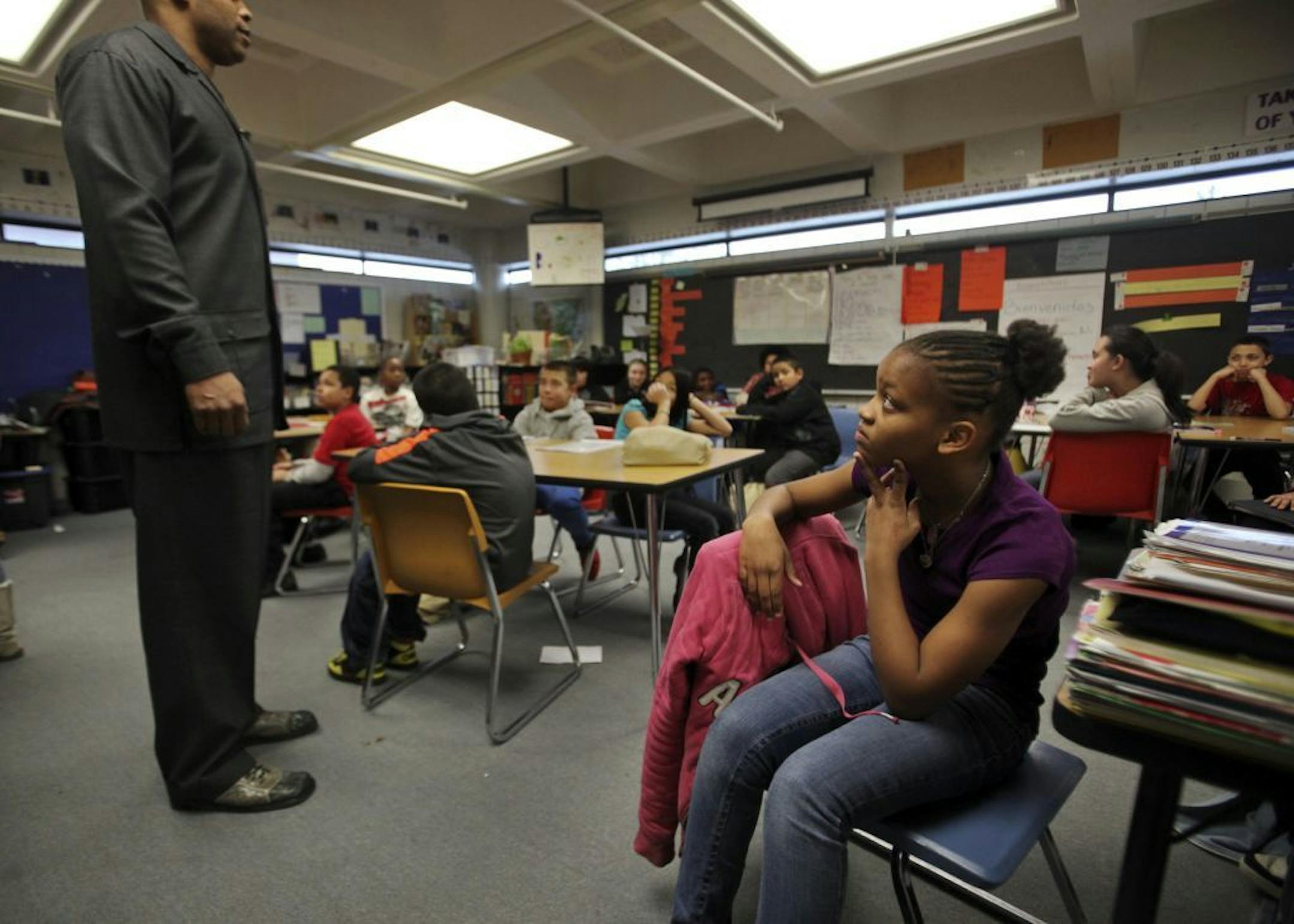 After a school field trip earlier in the day, Daytons Bluff Elementary School staff member Gary Trent visited students in their classrooms to let them know that they had done well and that he had heard positive comments about their behavior outside the school Wednesday, Feb. 6, 2013, in St. Paul, MN.