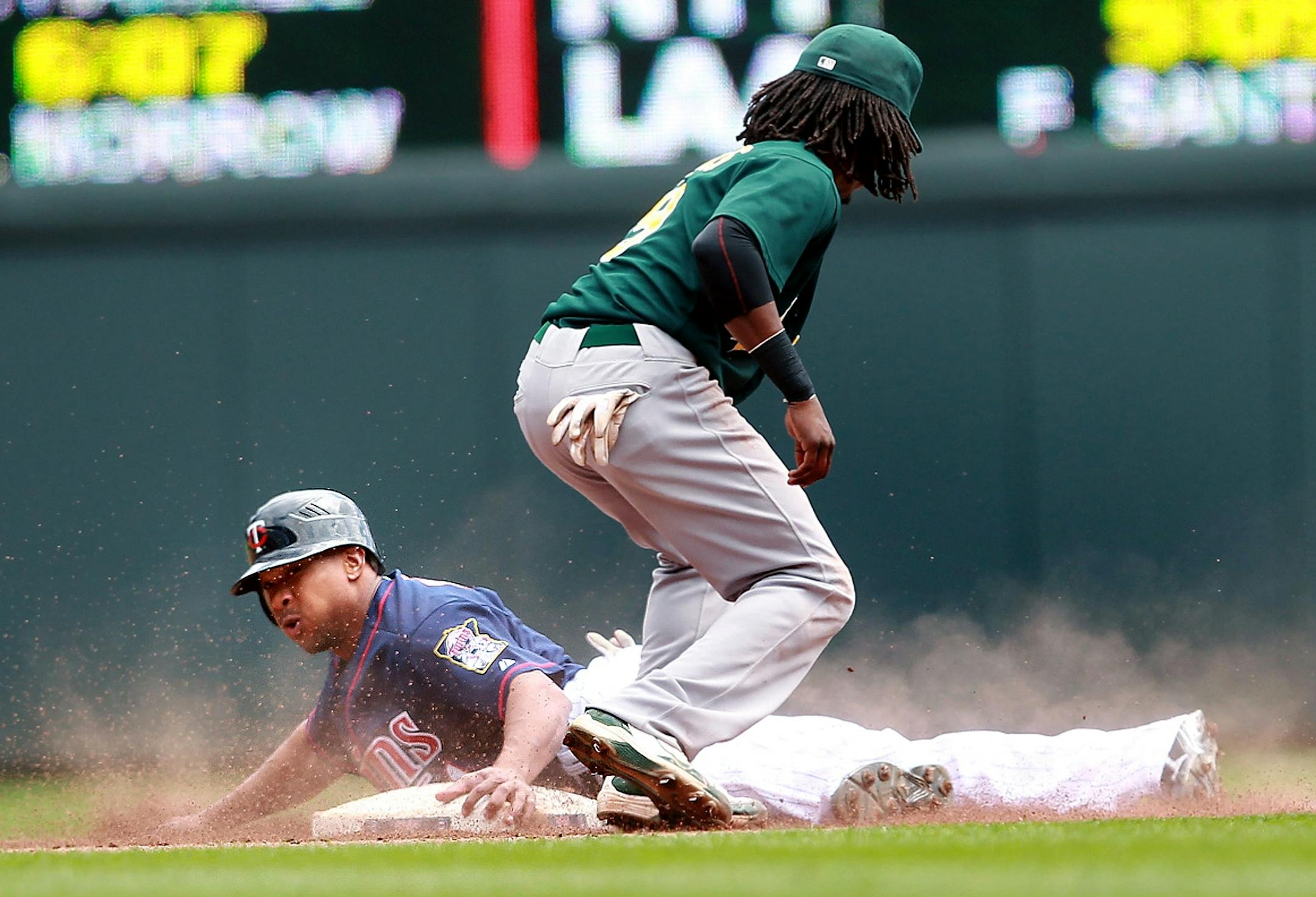 Twins outfielder Ben Revere (sliding)