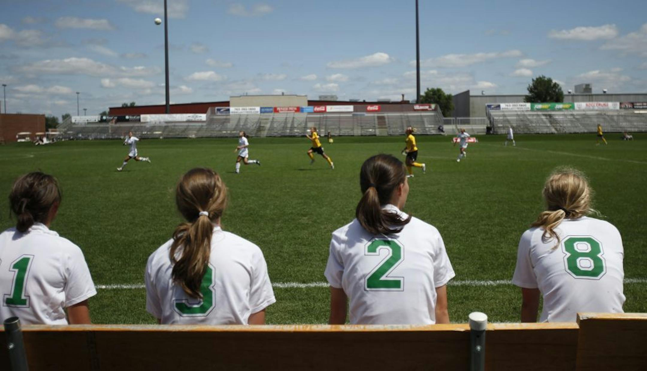 Players sat on the sidelines during a youth soccer tournament at the National Sports Center