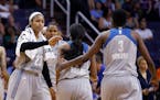 Minnesota Lynx's Maya Moore (23) celebrates a run against the Phoenix Mercury with Natasha Howard (3) and Jia Perkins, middle, during the second half 