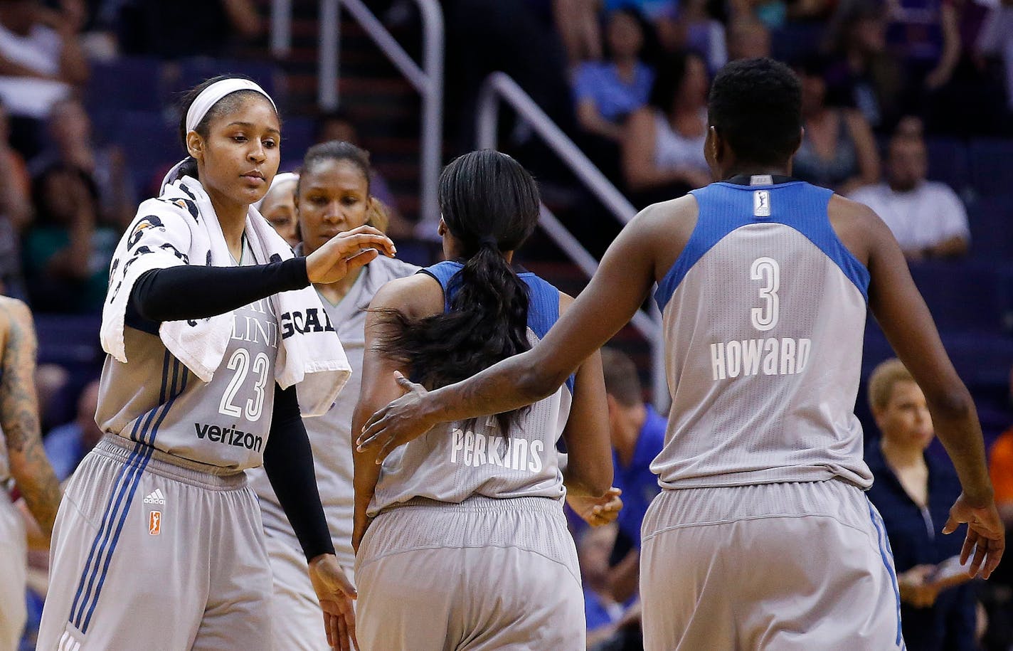 Minnesota Lynx's Maya Moore (23) celebrates a run against the Phoenix Mercury with Natasha Howard (3) and Jia Perkins, middle, during the second half of a WNBA basketball game Wednesday, May 25, 2016, in Phoenix. The Lynx defeated the Mercury 85-78. (AP Photo/Ross D. Franklin)