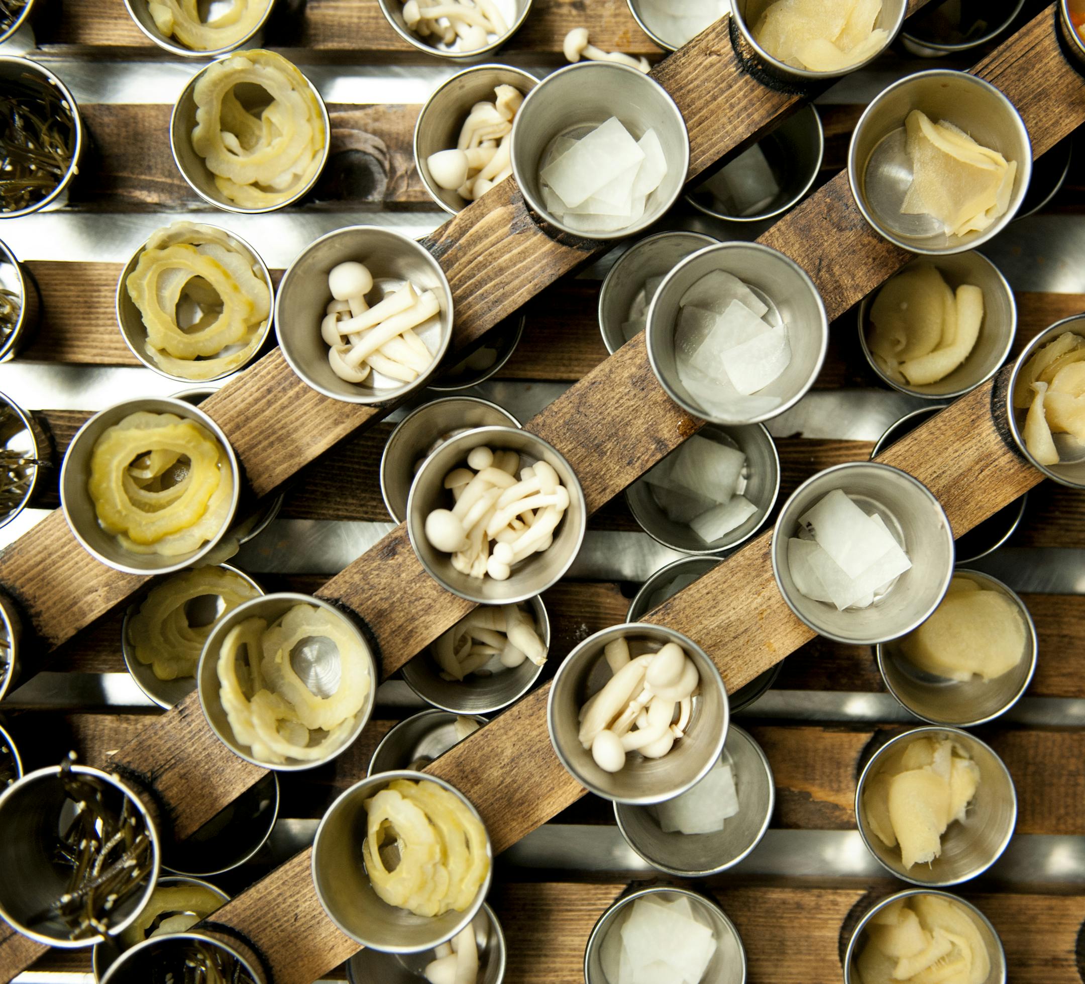 The pickle course is prepared to take out to guests at Umami. Photo by Leslie Plesser.