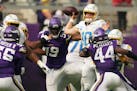 Los Angeles Chargers quarterback Justin Herbert (10) throws under pressure in the second quarter of an NFL game between the Minnesota Vikings and the 