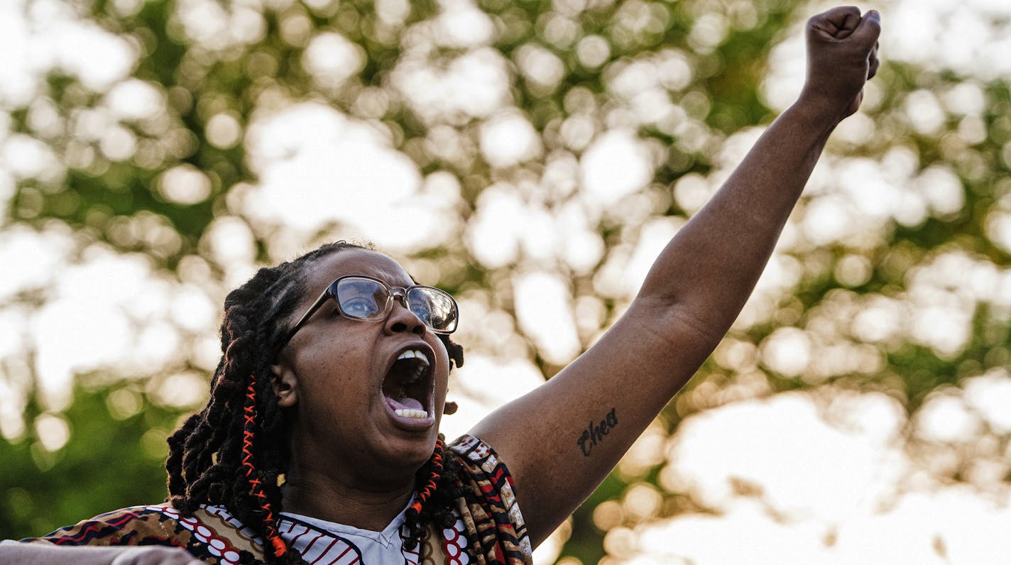 A protesters raises slogans as they skirmish with the National Guard near the 3rd Precinct before heading down Lake St. towards the 5th Precinct in Minneapolis, Minn., Friday, May 29, 2020. Peaceful protests turned increasingly violent in the aftermath the death of George Floyd during an arrest. Mayor Jacob Frey ordered a citywide curfew at 8 p.m. local time, beginning on Friday. (Richard Tsong-Taatarii/Star Tribune via AP)