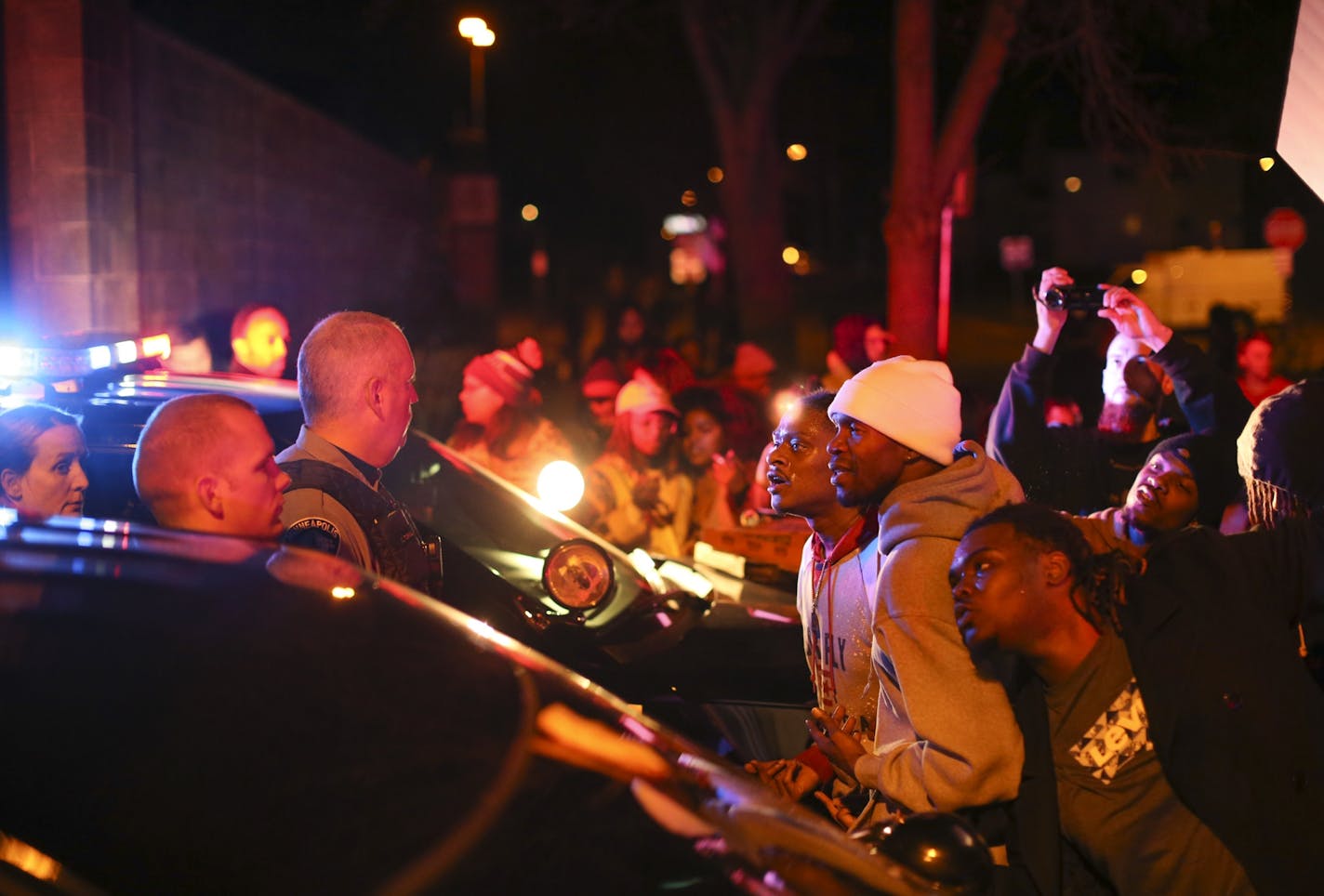 Demonstrators chanted at Minneapolis Police Officers at the side entrance to the 4th Precinct station on Morgan Ave. N. Sunday night in Minneapolis.