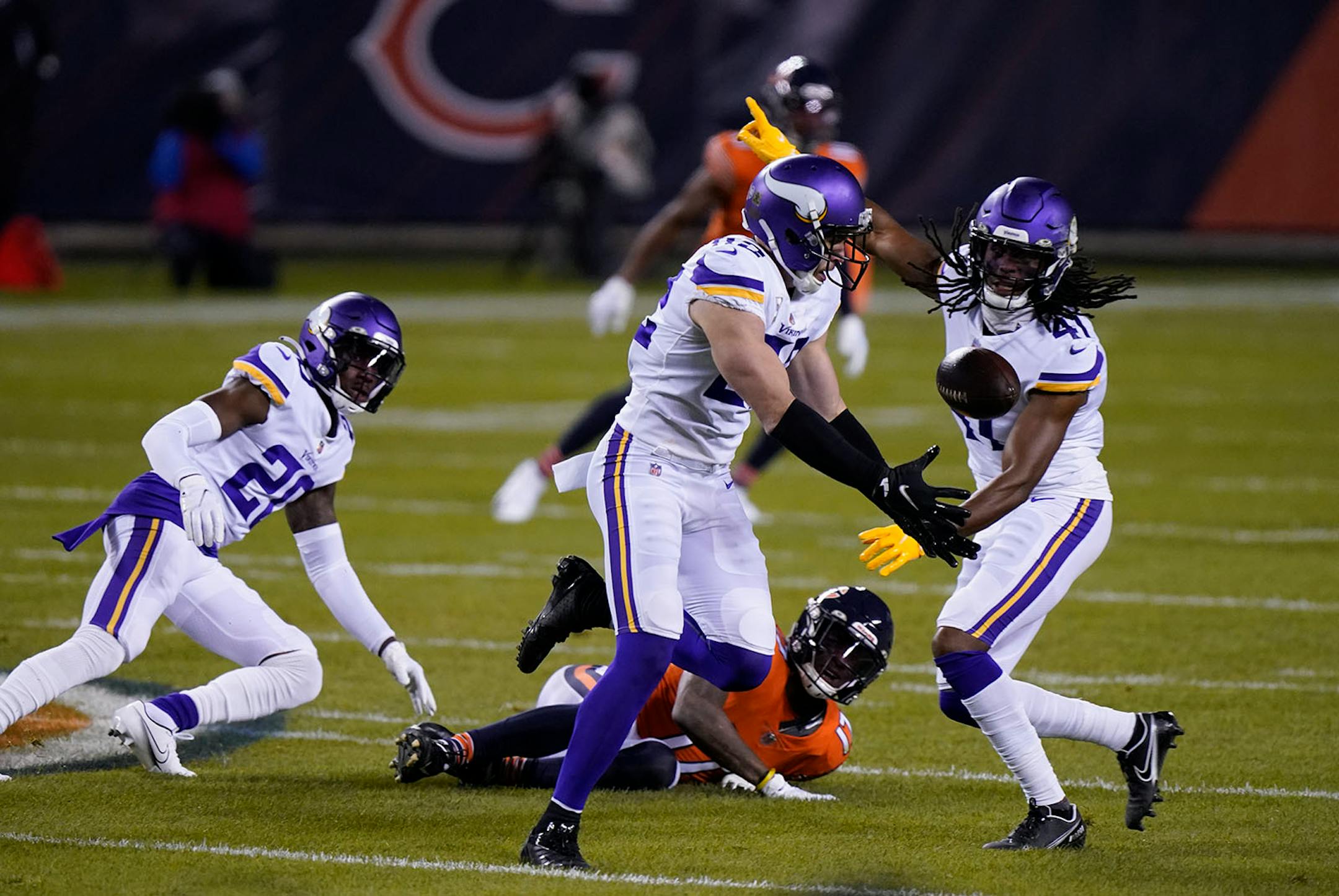 Minnesota Vikings safety Harrison Smith (22) intercepts a pass as teammates cornerback Jeff Gladney (20) and safety Anthony Harris (41) watch along with Chicago Bears wide receiver Anthony Miller (17) during the first half of an NFL football game Monday, Nov. 16, 2020, in Chicago. (AP Photo/Nam Y. Huh)