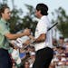 Bubba Watson, right, shakes hands with Jordan Spieth after winning the Masters golf tournament Sunday, April 13, 2014, in Augusta, Ga. (AP Photo/Charl