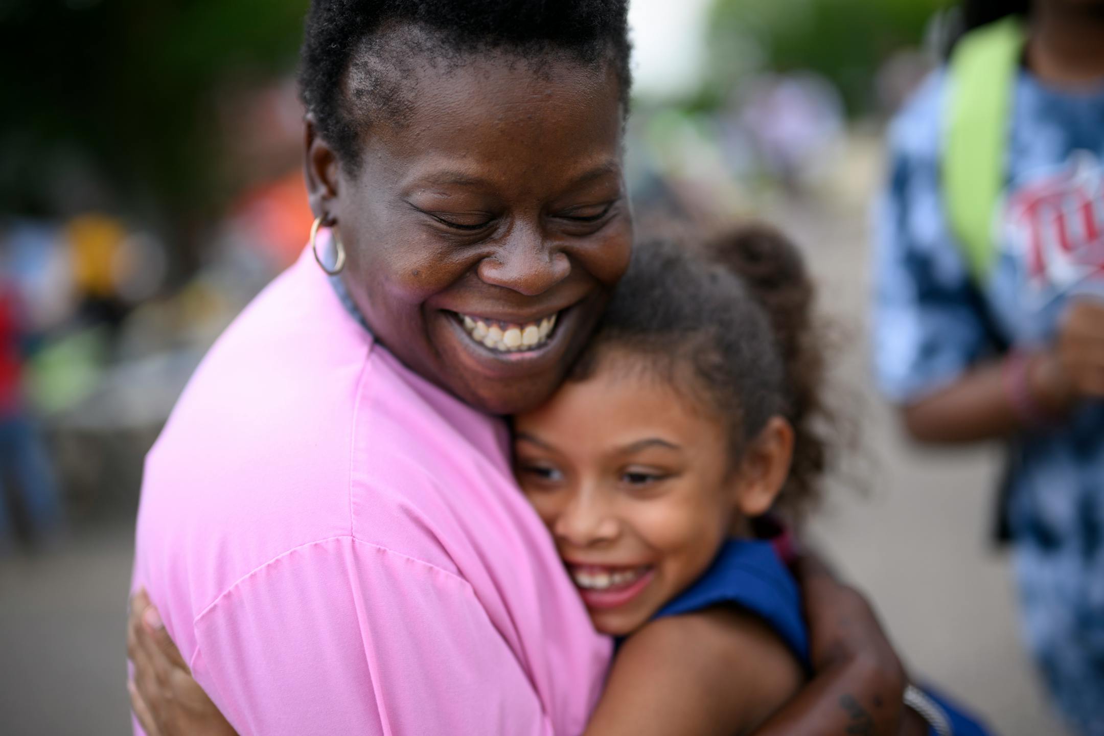 Annie Lampkin, of Minneapolis, hugs her 7-year old daughter, Diane Lundberg, after taking part in a drum circle dance.