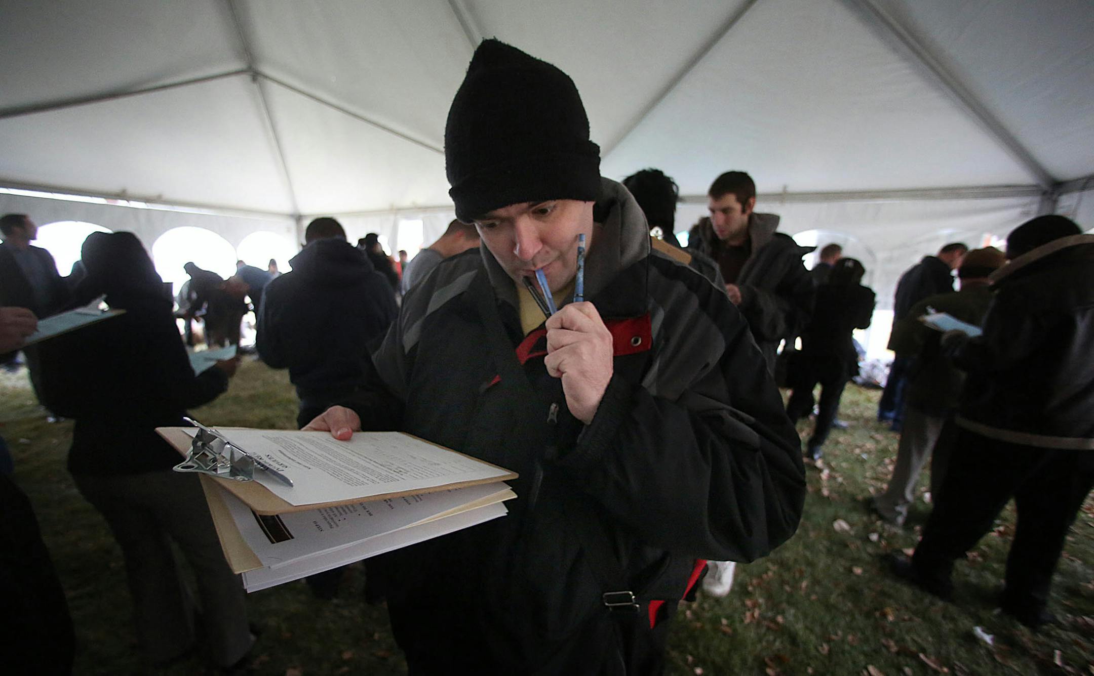 Brandon Hart, West St. Paul, filled out paperwork as he waited his turn for a job interview in November at Pearson Candy Co. in St. Paul. Hart said that he has been looking for work for about 14 months.