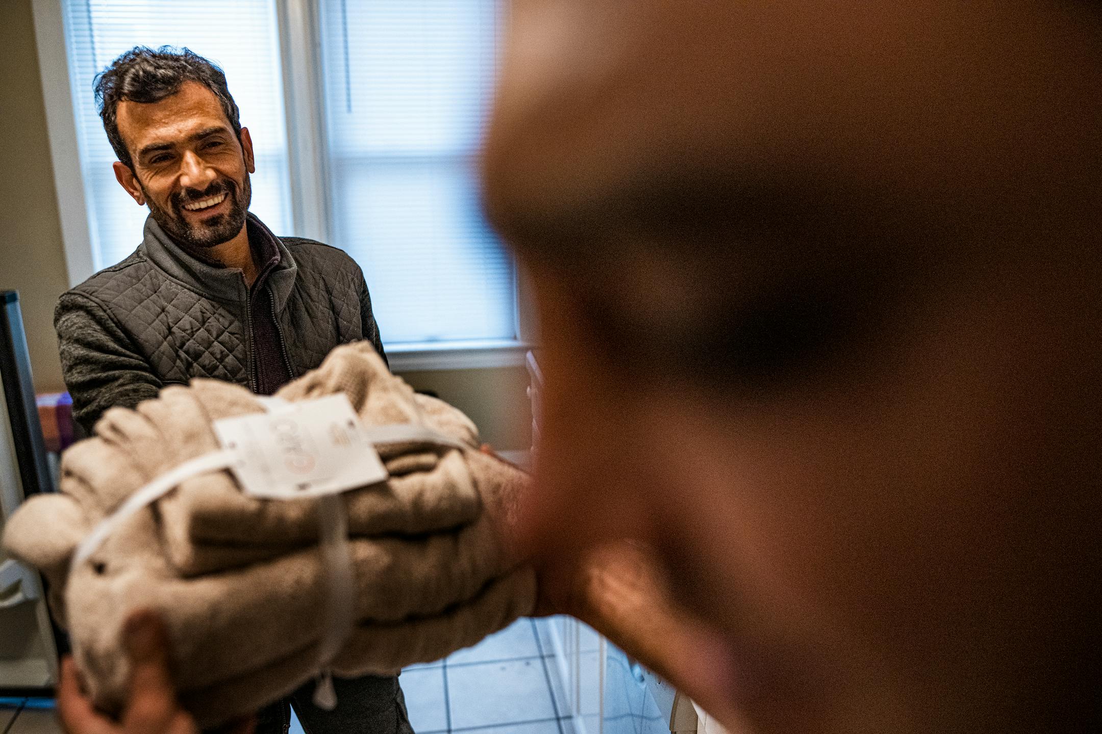 Mirwais Momand receives some bath towels provided by the International Institute of Minnesota in St. Paul.
