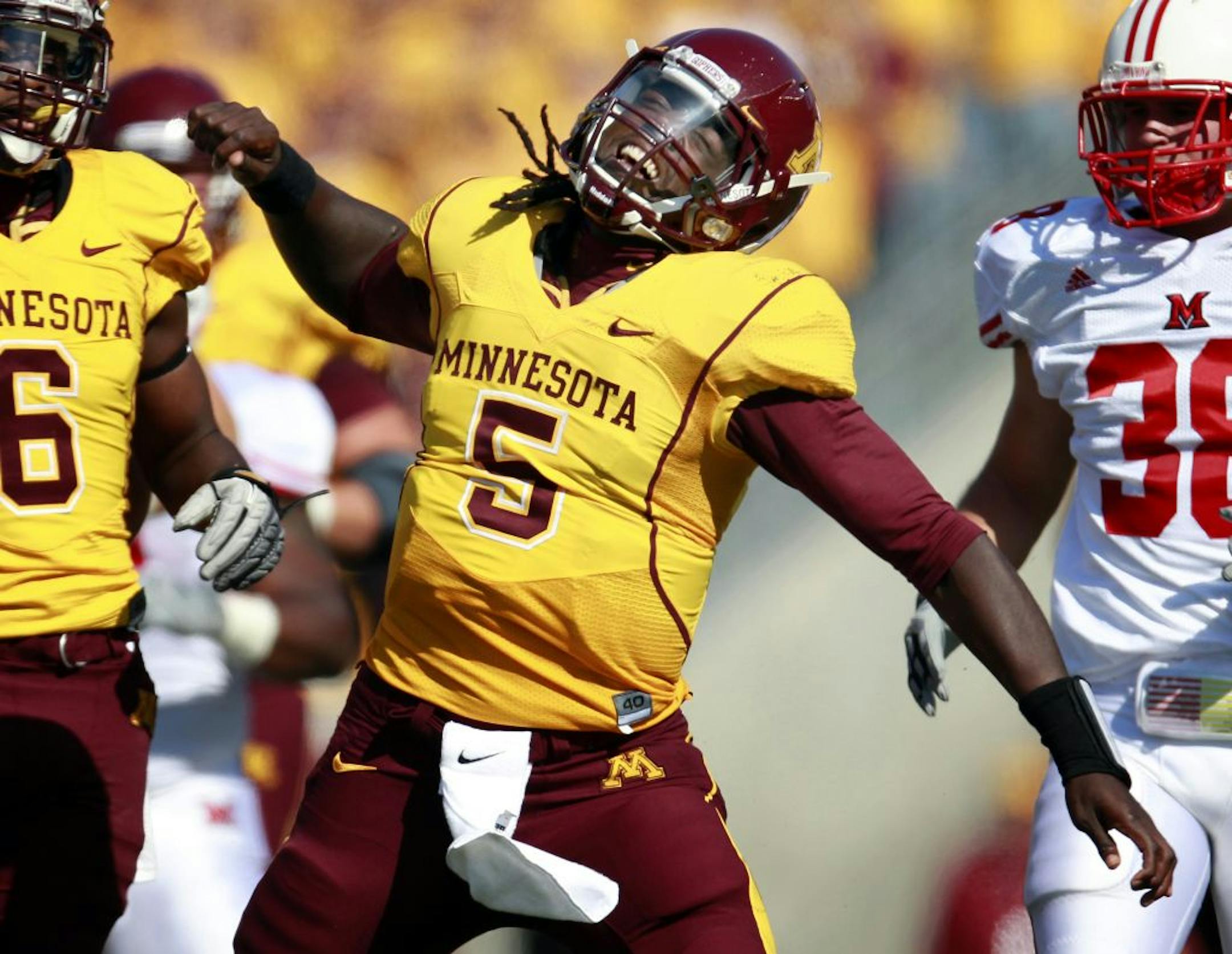 Minnesota quarterback Marquis Gray (5) reacted after a long run for a first down in the first quarter.