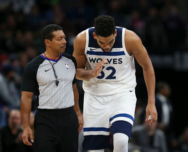 Minnesota Timberwolves center Karl-Anthony Towns (32) spoke with referee Bill Kennedy in the fourth quarter on his way to the Wolves bench for a time 