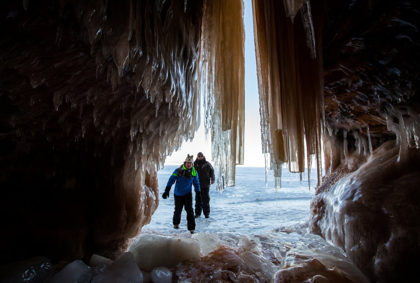 Edward Mitchell, front, of Detroit, and James Kuhn, of Seattle, explore an ice cave at the Apostle Islands National Lakeshore on Lake Superior, Friday, Feb. 27, 2015, near Bayfield, Wis.