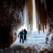 Edward Mitchell, front, of Detroit, and James Kuhn, of Seattle, explore an ice cave at the Apostle Islands National Lakeshore on Lake Superior, Friday