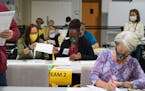 Workers recount election ballots by hand in Gwinnett County, Georgia on Friday, Nov. 13, 2020. President Donald Trump's legal team said Saturday that 