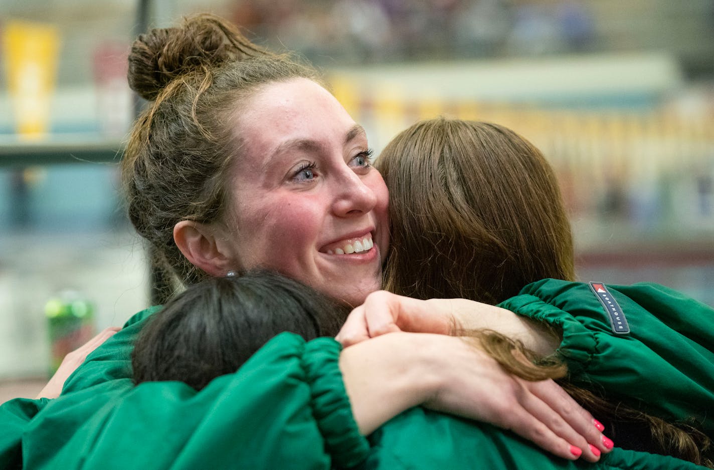 Katie McCarthy embraces her Edina teammates after they won the Class 2A girl's swimming state championship Friday, Nov. 18, 2022 at the Jean K. Freeman Aquatic Center in Minneapolis. ]