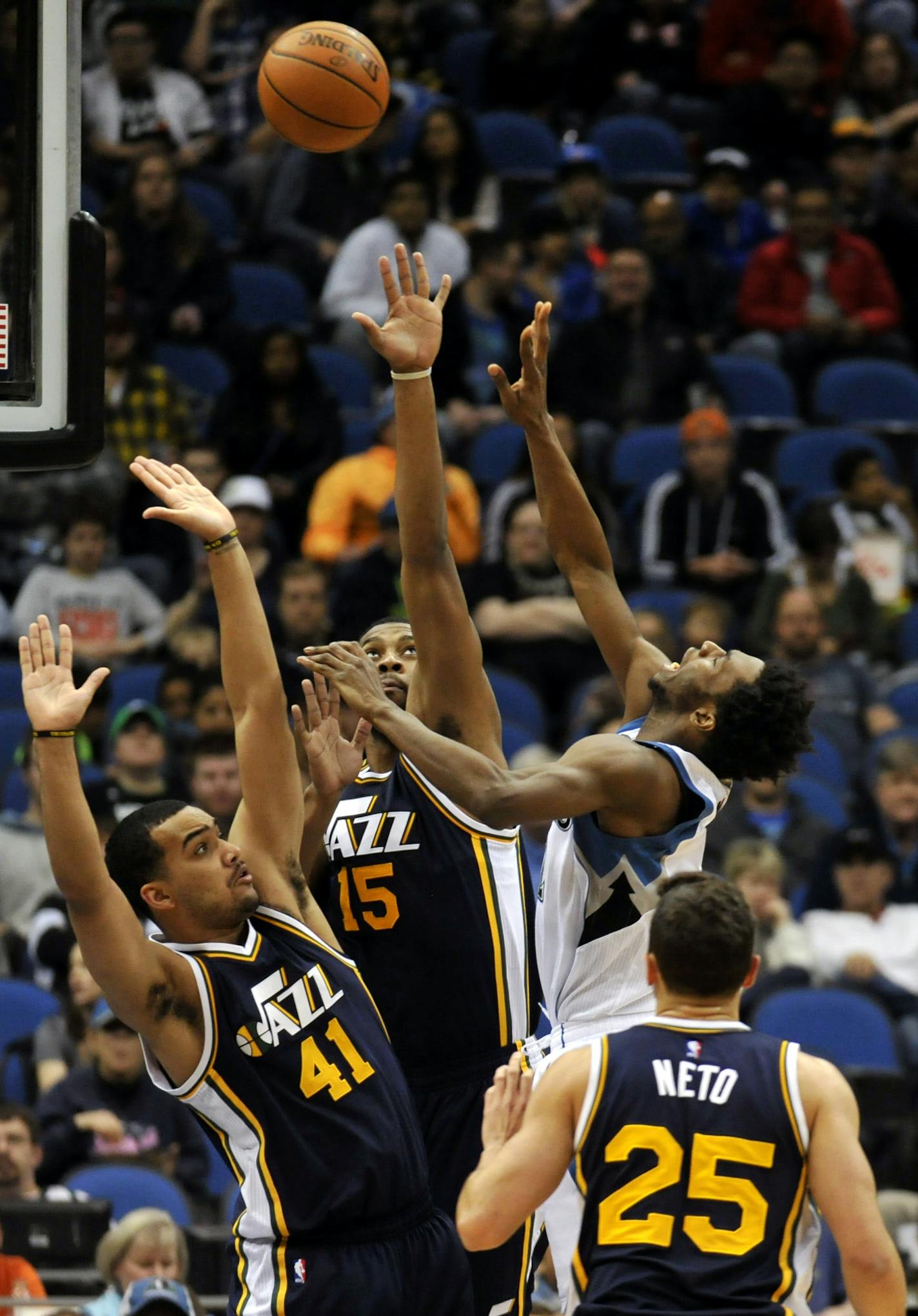 Minnesota Timberwolves&#xed; Andrew Wiggins shoots against Utah Jazz&#xed;s Trey Lyles (41), Derrick Favors (15), and Raul Neto (25), of Brazil, of an NBA basketball game on Saturday, March 26, 2016, in Minneapolis.(AP Photo/Hannah Foslien)