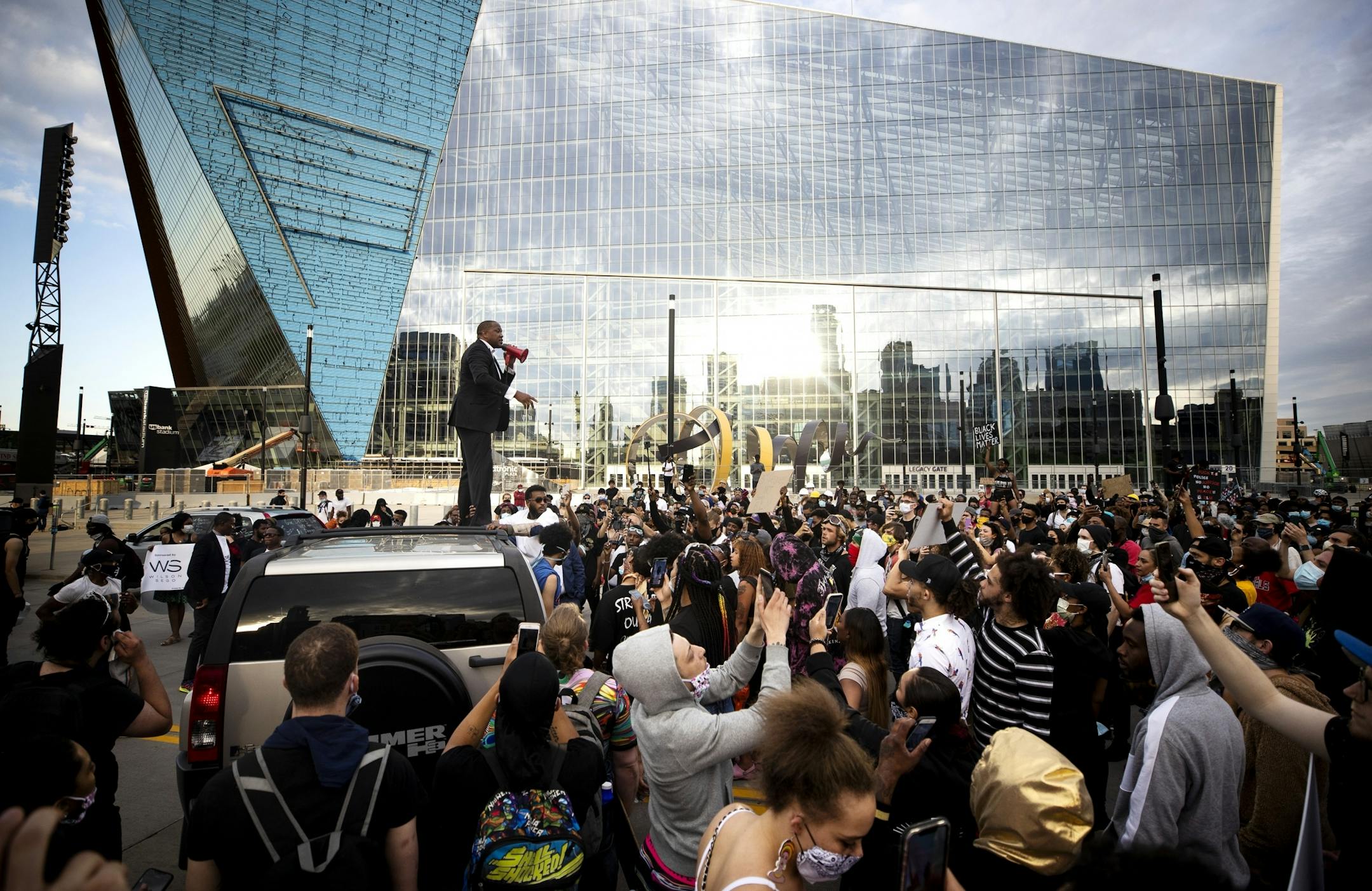 Joe Collins spoke to a group of protestors from the roof a a car in front of U.S. Banks Stadium. They later marched to 35 W and Washington Avenue .
