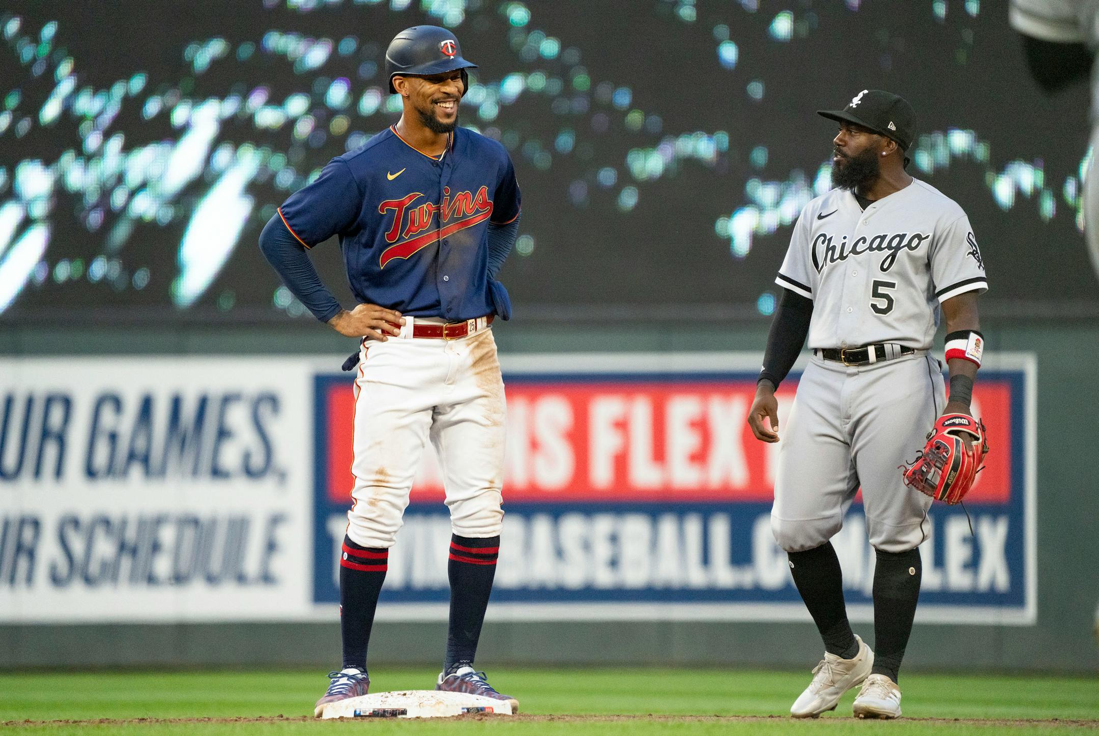 Minnesota Twins designated hitter Byron Buxton (25) smiles as he chats with Chicago White Sox second baseman Josh Harrison (5) in the third inning Friday, July 15, 2022 at Target Field in Minneapolis. ]
