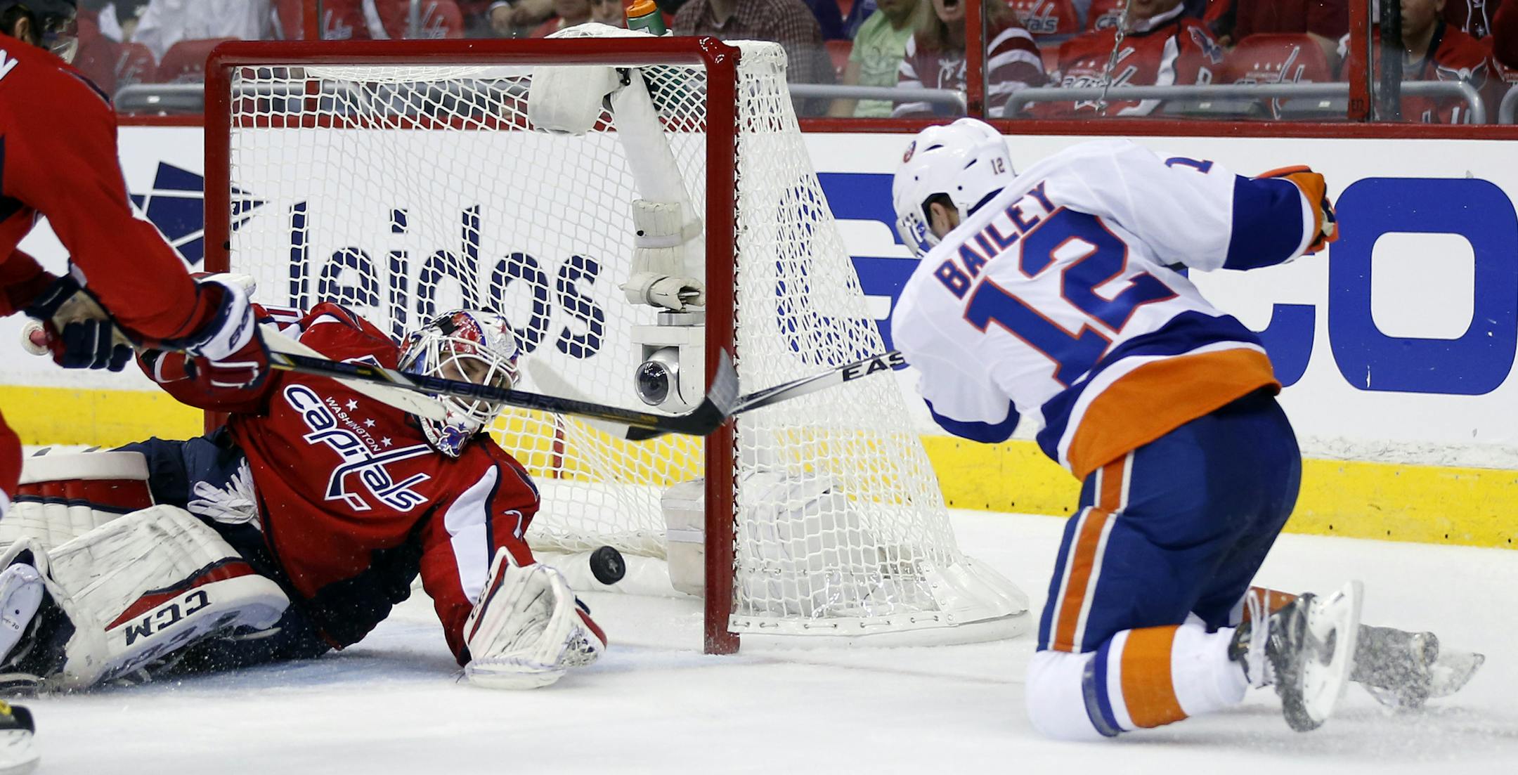 New York Islanders left wing Josh Bailey (12) scores a goal past Washington Capitals goalie Braden Holtby during the second period of Game 1 in a first-round NHL hockey Stanley Cup playoffs series, Wednesday, April 15, 2015, in Washington. (AP Photo/Alex Brandon)
