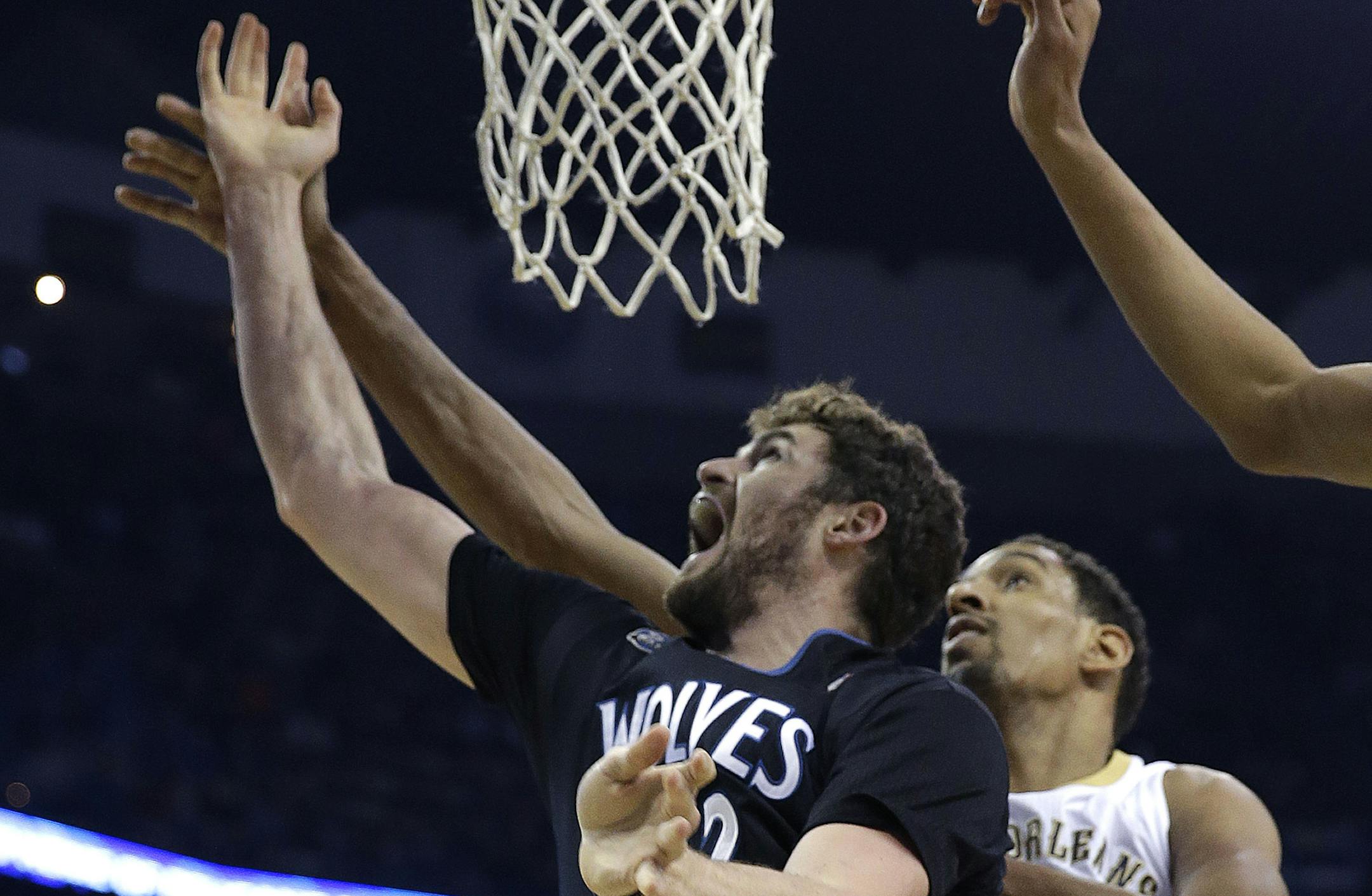 Minnesota Timberwolves power forward Kevin Love goes to the basket in front of New Orleans Pelicans center Alexis Ajinca (42) in the first half of an NBA basketball game in New Orleans, Friday, Feb. 7, 2014. (AP Photo/Gerald Herbert)