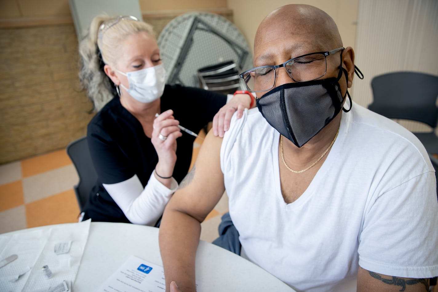 Hennepin Healthcare nurse Alison Grover, cq, administered a Pfizer vaccine to Phillip Larkins at Fellowship Missionary Baptist Church, Thursday, February 11, 2021 in Minneapolis, MN. Grover said that he had previously signed up for a lottery and had no luck, but was able to get in at the church fairly quickly. ] ELIZABETH FLORES • liz.flores@startribune.com