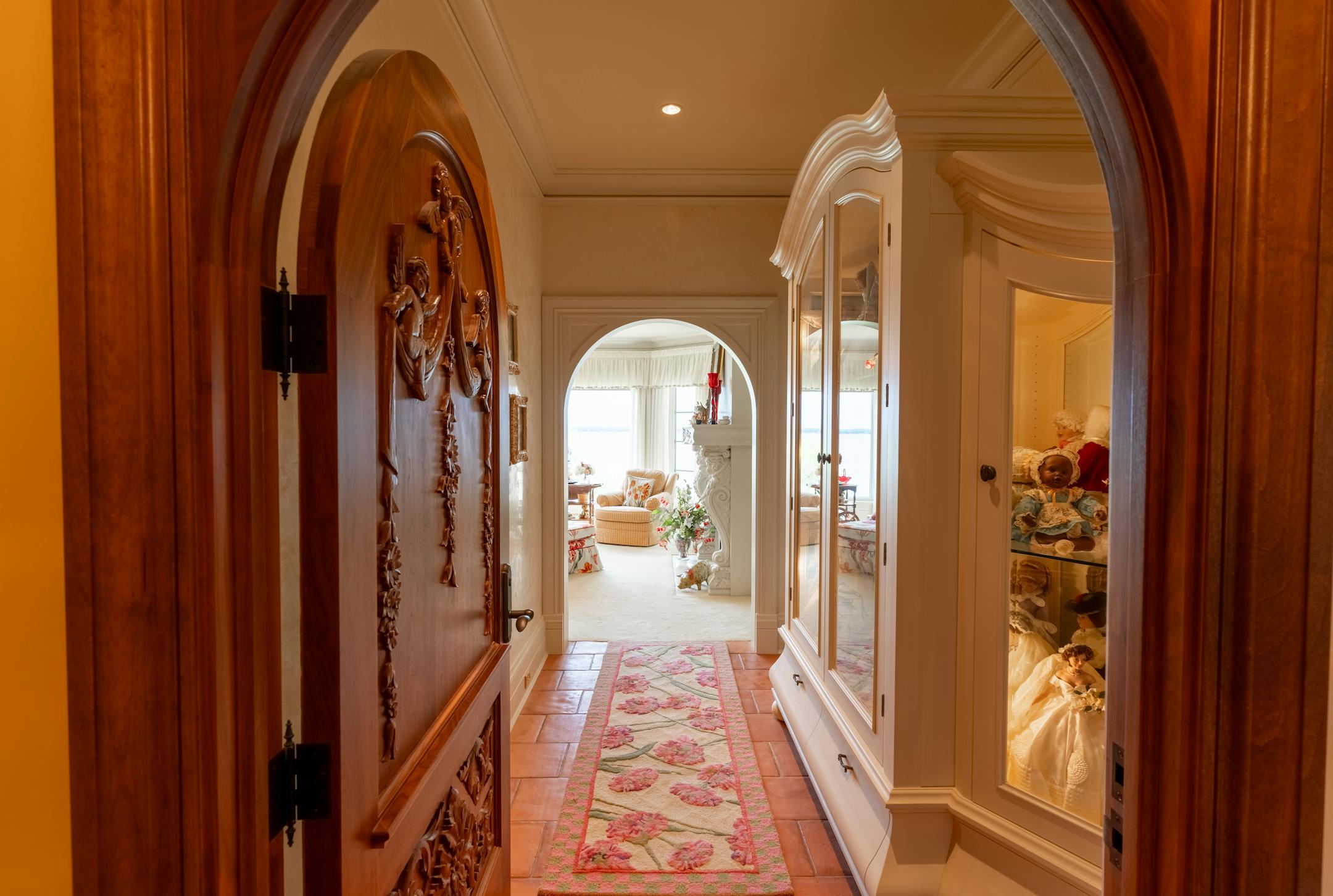A hand-carved wood door leads to the primary suite.