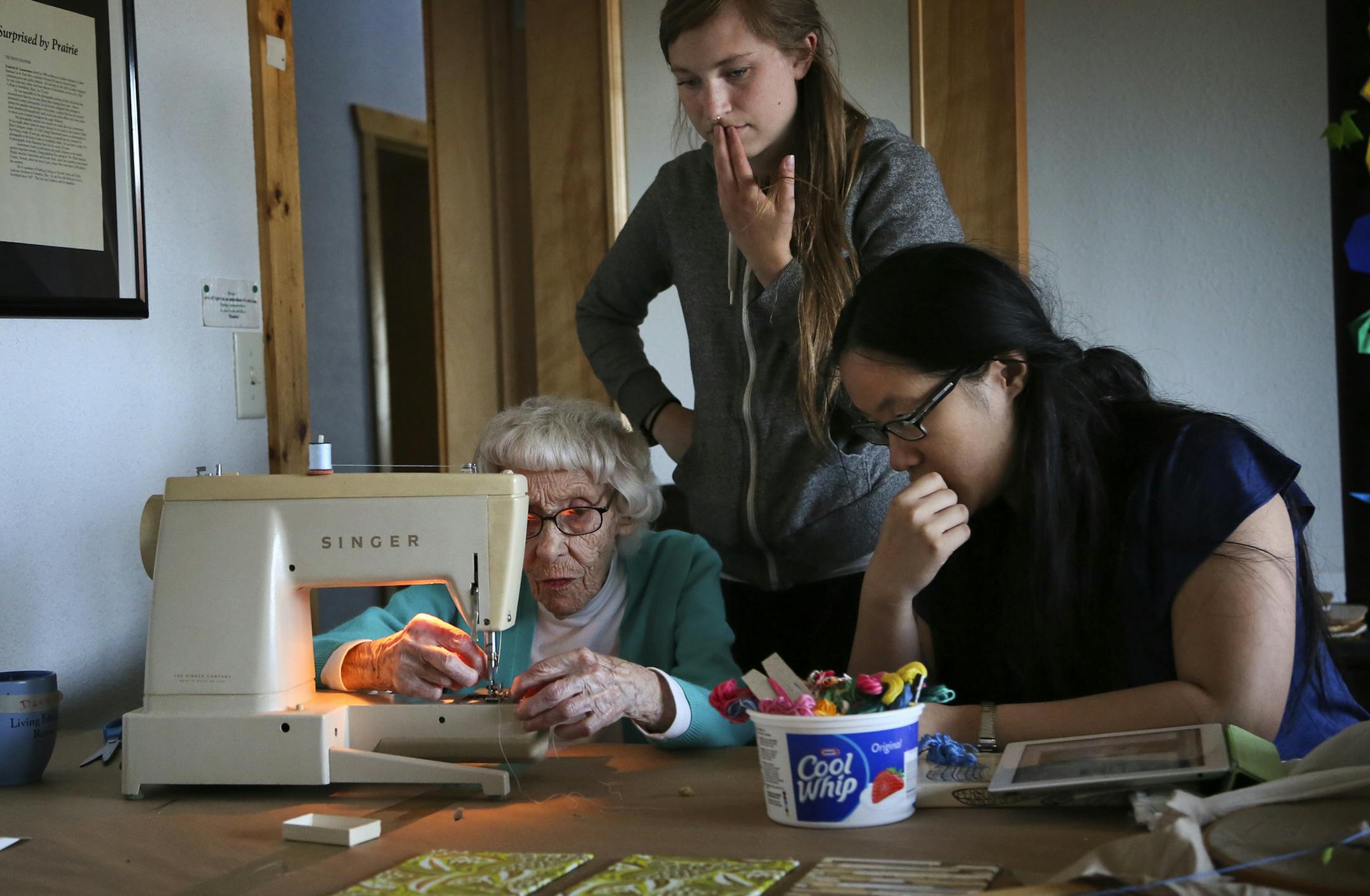 Ardes Shea, the &#x201a;&#xc4;&#xfa;camp grandmother,&#x201a;&#xc4;&#xf9; attempts to thread a donated Singer sewing machine as U of M philosophy camp apprentice Anna Lohse, middle, and student Dawn Jiang, right, try to assist Sunday, June 2, 2013, in Windom, MN. In the end, Jiang brought out her iPad for a Youtube tutorial on the subject and learned the sewing machine was missing an important part.](DAVID JOLES/STARTRIBUNE) djoles@startribune.com A University of Minnesota philosophy camp takes