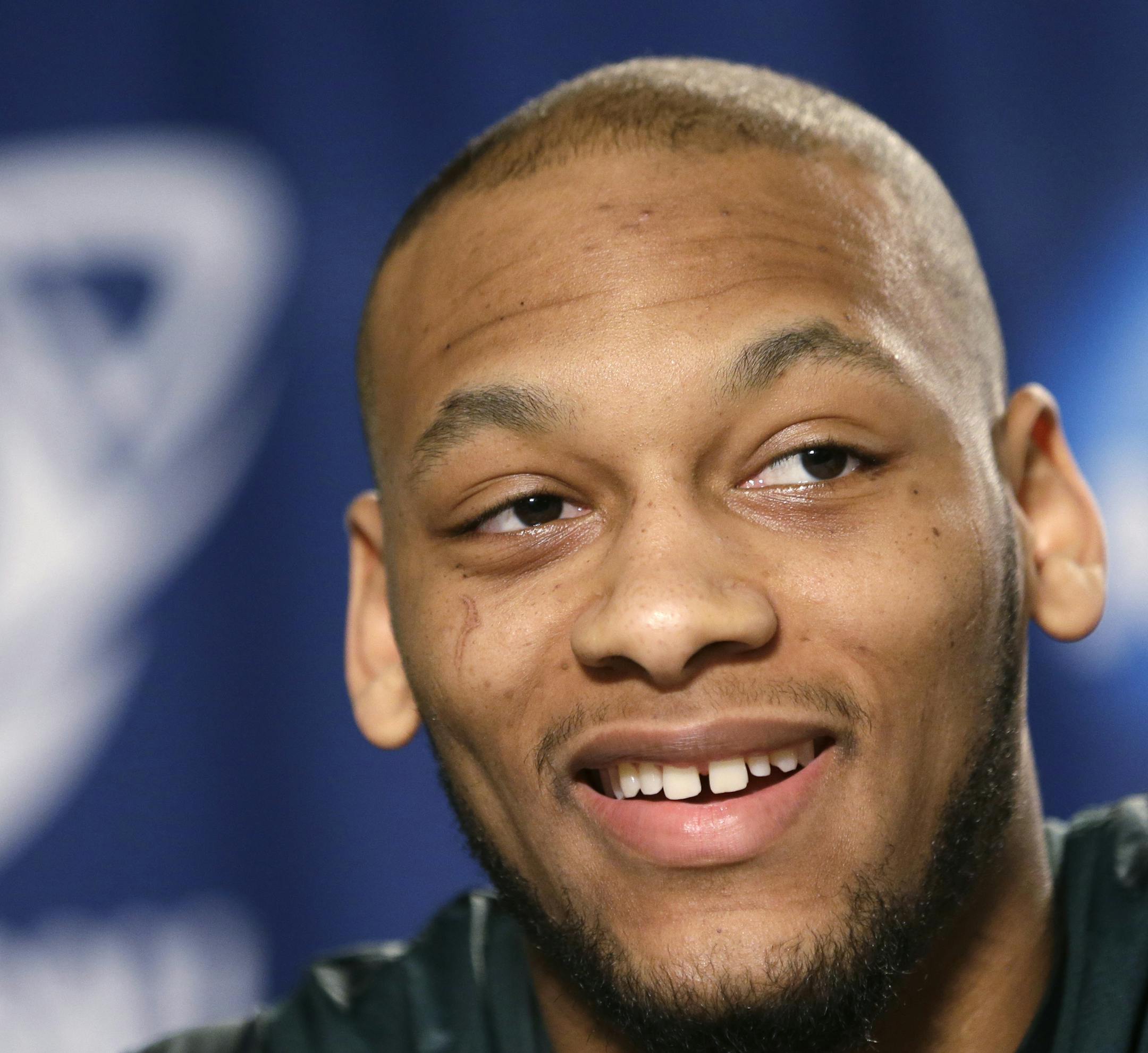 Michigan State's Adreian Payne smiles while answering a question at a news conference before the third round of the NCAA men's college basketball tournament in Spokane, Wash., Friday, March 21, 2014. Michigan State plays Harvard on Saturday. (AP Photo/Elaine Thompson) ORG XMIT: WAET107