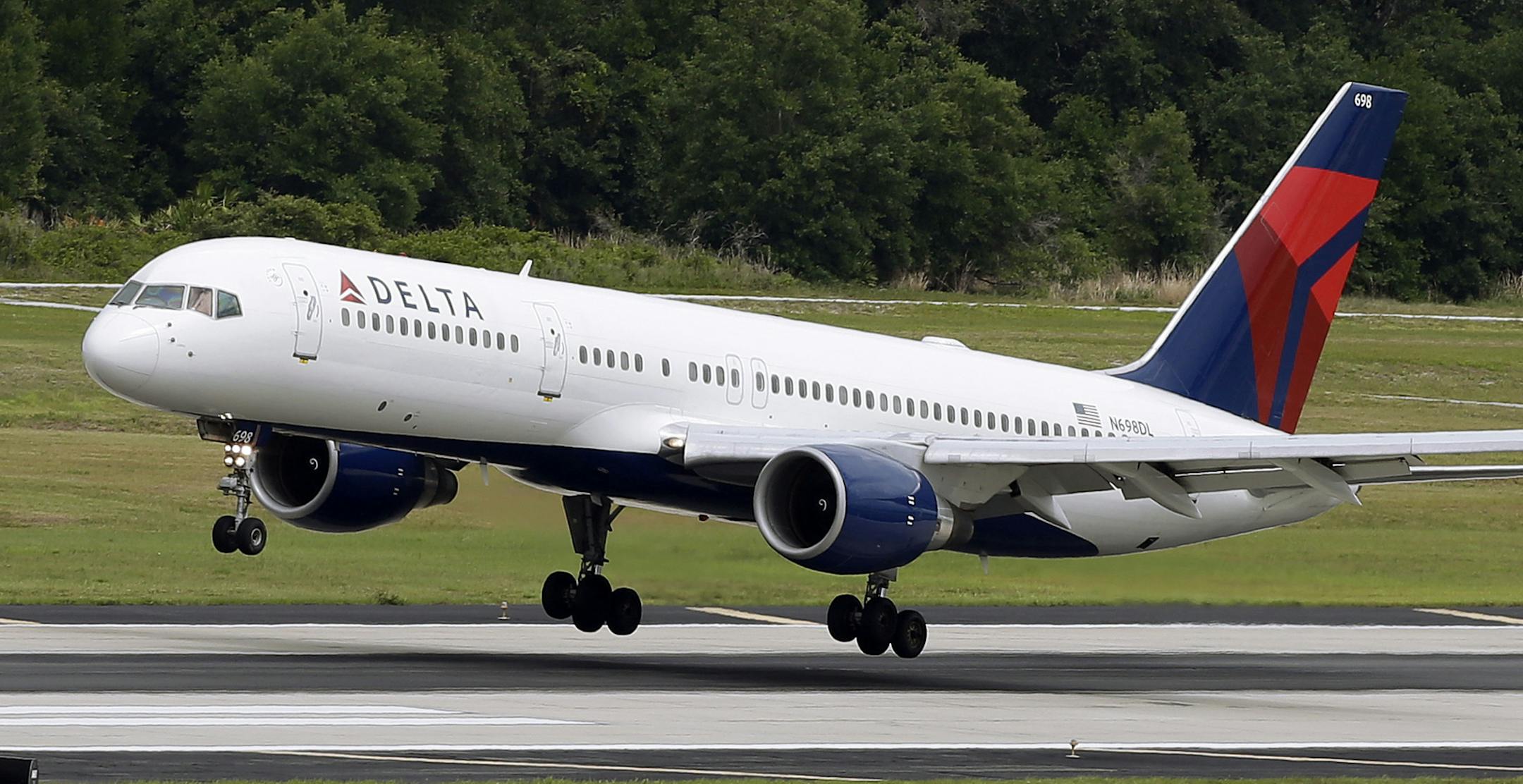 FILE - In this Thursday, May 15, 2014, file photo, a Delta Air Lines Boeing 757-232 lands at the Tampa International Airport in Tampa, Fla. Southwest Airlines caught rivals and Wall Street by surprise when it cut many U.S. fares by $5 each way, applicable to tickets bought within seven days of departure. Meanwhile, Delta Air Lines was busy raising fares on domestic routes by $5 each way. And it did not match Southwest's lower fares where the two carriers compete, a Delta spokesman said Thursday,