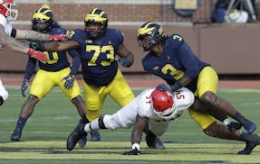 Michigan defensive linemen Rashan Gary (3) and Maurice Hurst (73) go up against the Rutgers offensive line during the first half of an NCAA college fo
