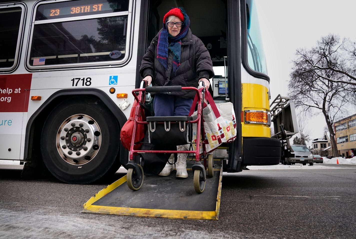 Joy Rindels-Hayden, 87, is waging a prolonged campaign to pass a state law to improve bus safety during the dangerous winter months after she suffered a near-debilitating brain injury years ago while getting off a metro bus and was seen getting off a bus near a Southside food pantry Friday, Jan. 13, 2023 in Minneapolis, Minn. ]