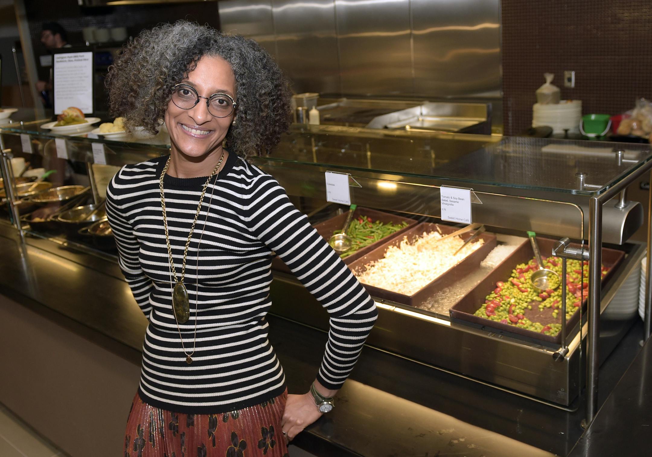 FILE - In this Sept. 14, 2016 file photo, Carla Hall, the Chew co-host and Top Chef alum, poses for a photo inside the North Star Cafe at the National Museum of African American History and Culture in Washington. The museum, opening later this month, will be an experience aimed at feeding the soul, literally. The Sweet Home Cafe is the museum's restaurant, with a menu featuring culturally authentic fare and modern-day-inspired foods. The restaurant is a journey through the agricultural south, Cr