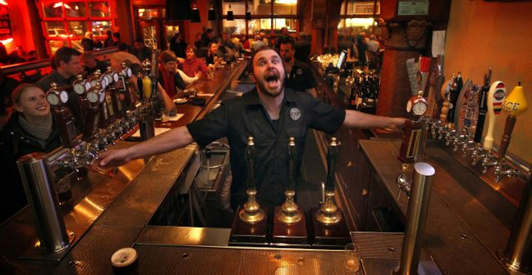 The Town Hall Tap is making a big hit on the corner of 48th and Chicago in South Minneapolis for both for families and beer lovers. Bartender Rolf Bruhn mugs for the camera while he pours two on a busy Friday night.