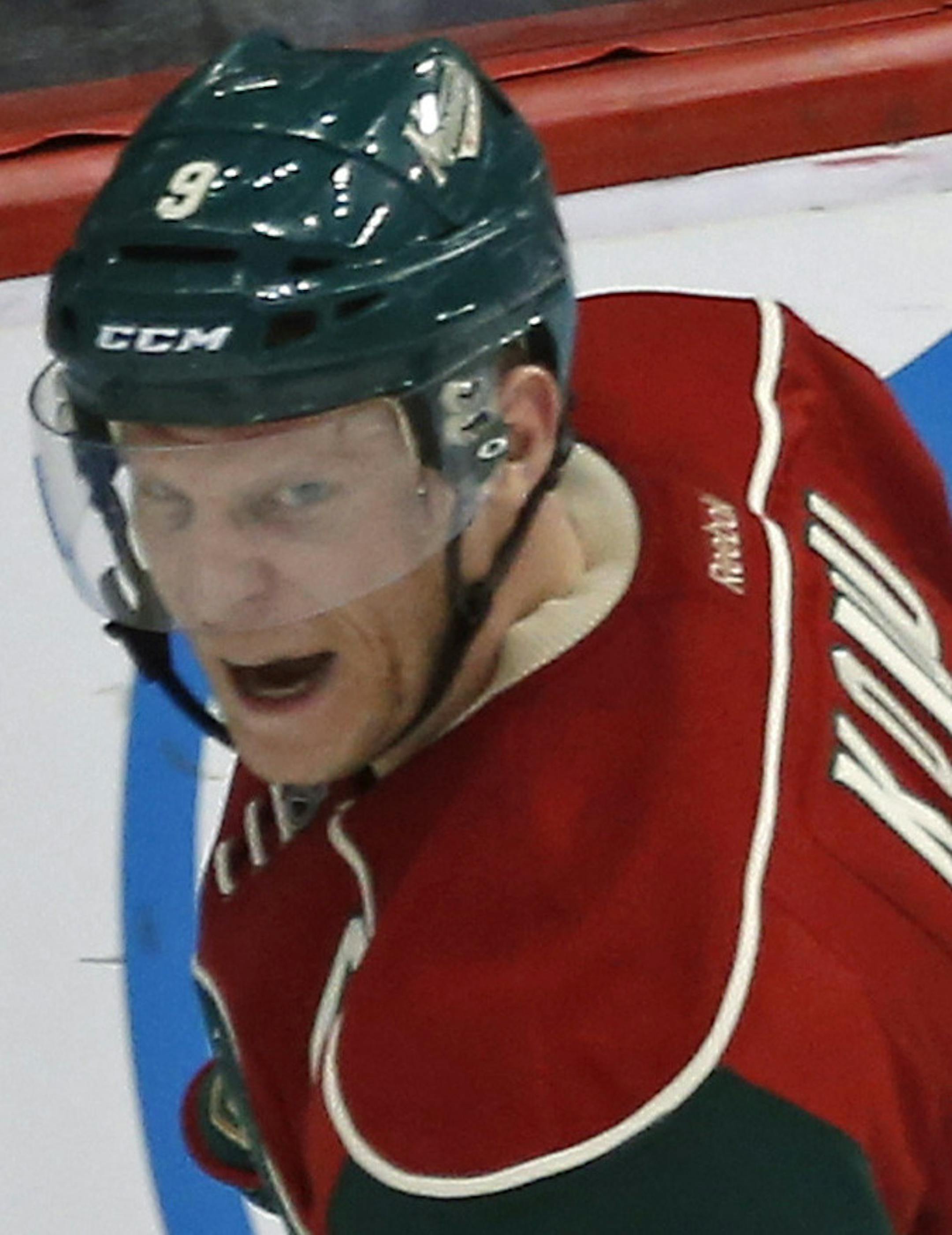 Minnesota Wildís Mikko Koivu, of Finland, celebrates his game-winning goal against Calgary Flames goalie Karri Ramo, of Finland, in the third period of an NHL hockey game, Friday, March 27, 2015, in St. Paul, Minn. The Wild won 4-2. (AP Photo/Jim Mone)