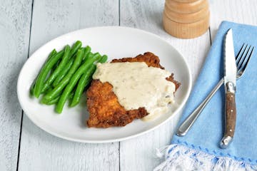 Buttermilk Brined Country Fried Pork Chops with Creamy Black Pepper Gravy is dinner tonight. Credit: Meredith Deeds, Special to the Star Tribune