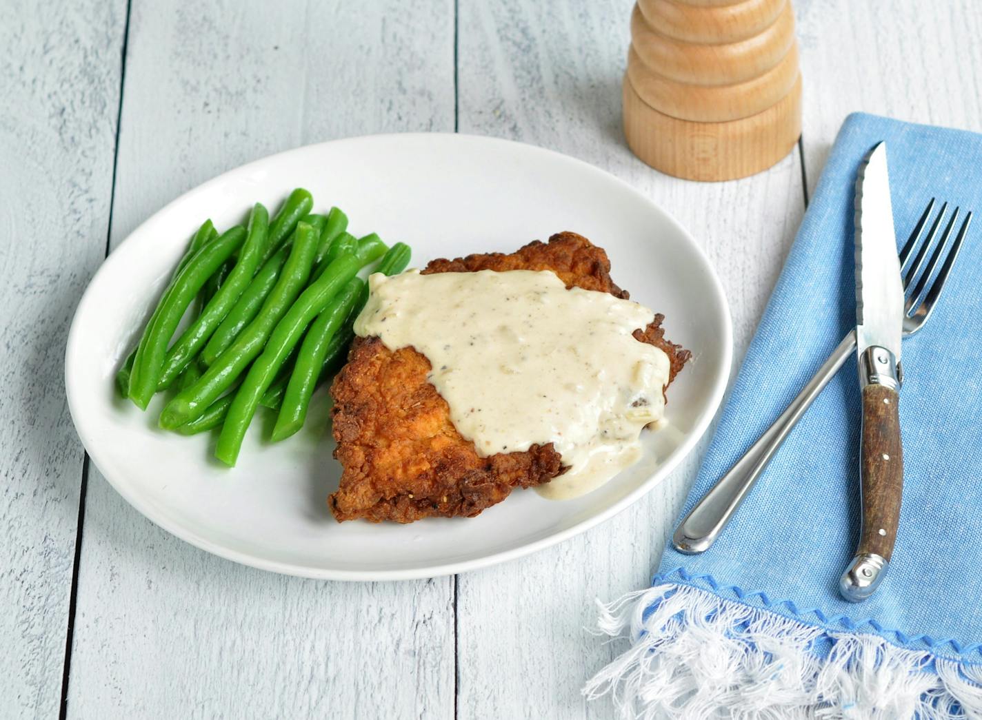 Buttermilk Brined Country Fried Pork Chops with Creamy Black Pepper Gravy is dinner tonight. Credit: Meredith Deeds, Special to the Star Tribune