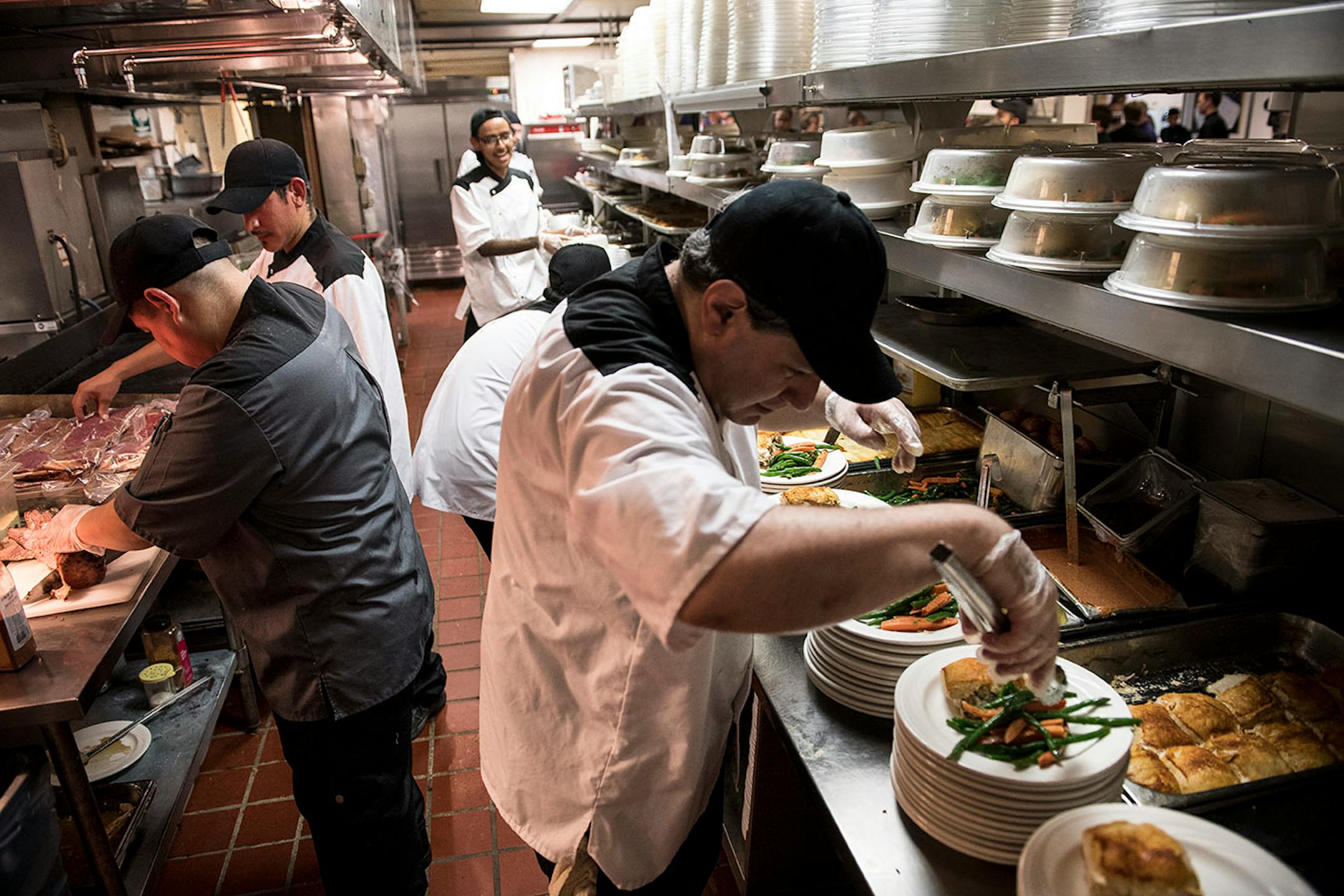 Cooks plated hundreds of dishes in the kitchen during a Friday night at Chanhassen Dinner Theatres.