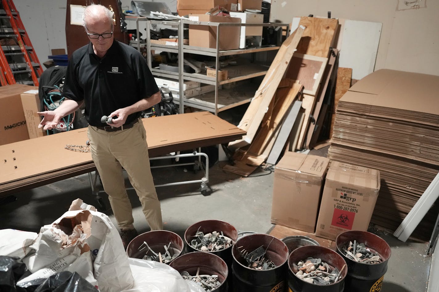 Paul Maher, owner of Cremation &amp; Trade Services Inc., holds out a metal knee replacement from a person who was cremated at his facility Wednesday, Dec. 6, 2023 in St. Paul, Minn. Maher collects all metal and non metal items that don't burn in the process and sends them to a recycler. ] ANTHONY SOUFFLE • anthony.souffle@startribune.com