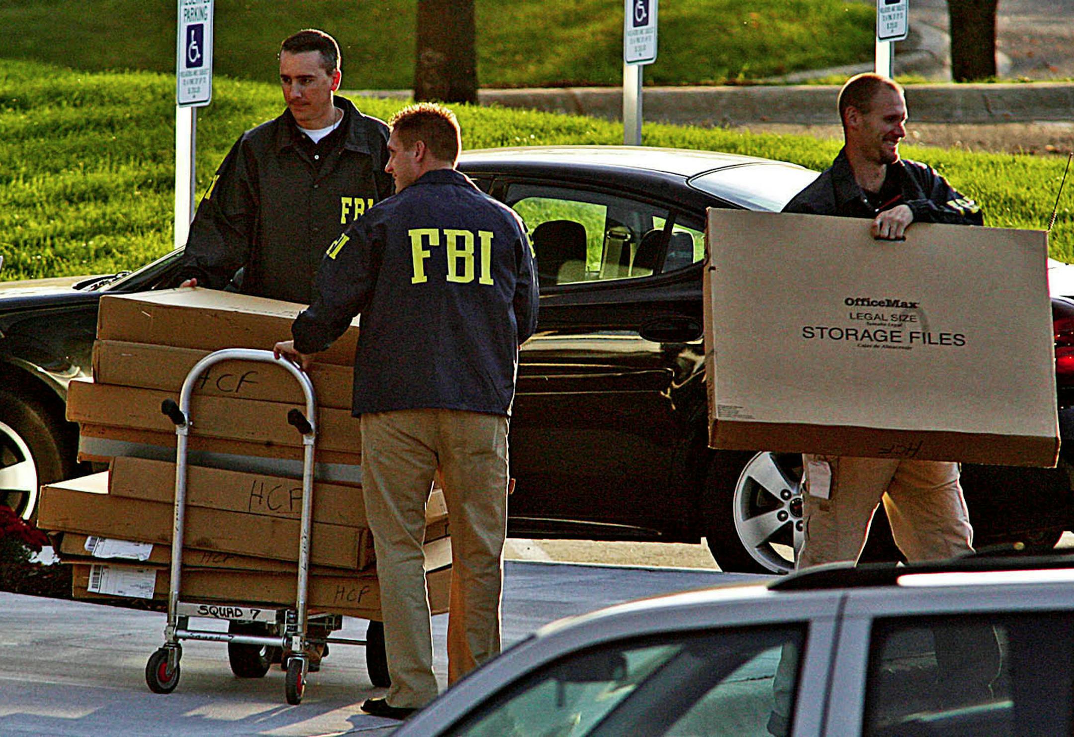 ** ADVANCE FOR MONDAY OCT. 26 ** **FILE** In this Sept. 24, 2008 file photo, FBI agents haul boxes of unknown items from the Petters Group headquarters building in Minnetonka, Minn. Tom Petters, whose Petters Group Worldwide had stakes in companies including Polaroid and Sun Country Airlines, goes on trial beginning Oct. 26 accused of orchestrating a multibillion dollar Ponzi scheme. (AP Photo/The Star Tribune, Marlin Levison, file)**ST. PAUL OUT, NO MAGS, NO SALES, NO TV**