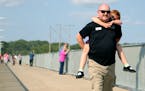 Rich Gates, Brooklyn Park council member, and daughter Parker, 7, toured the newly reopened walkway on the Coon Rapids Dam in Brooklyn Park.