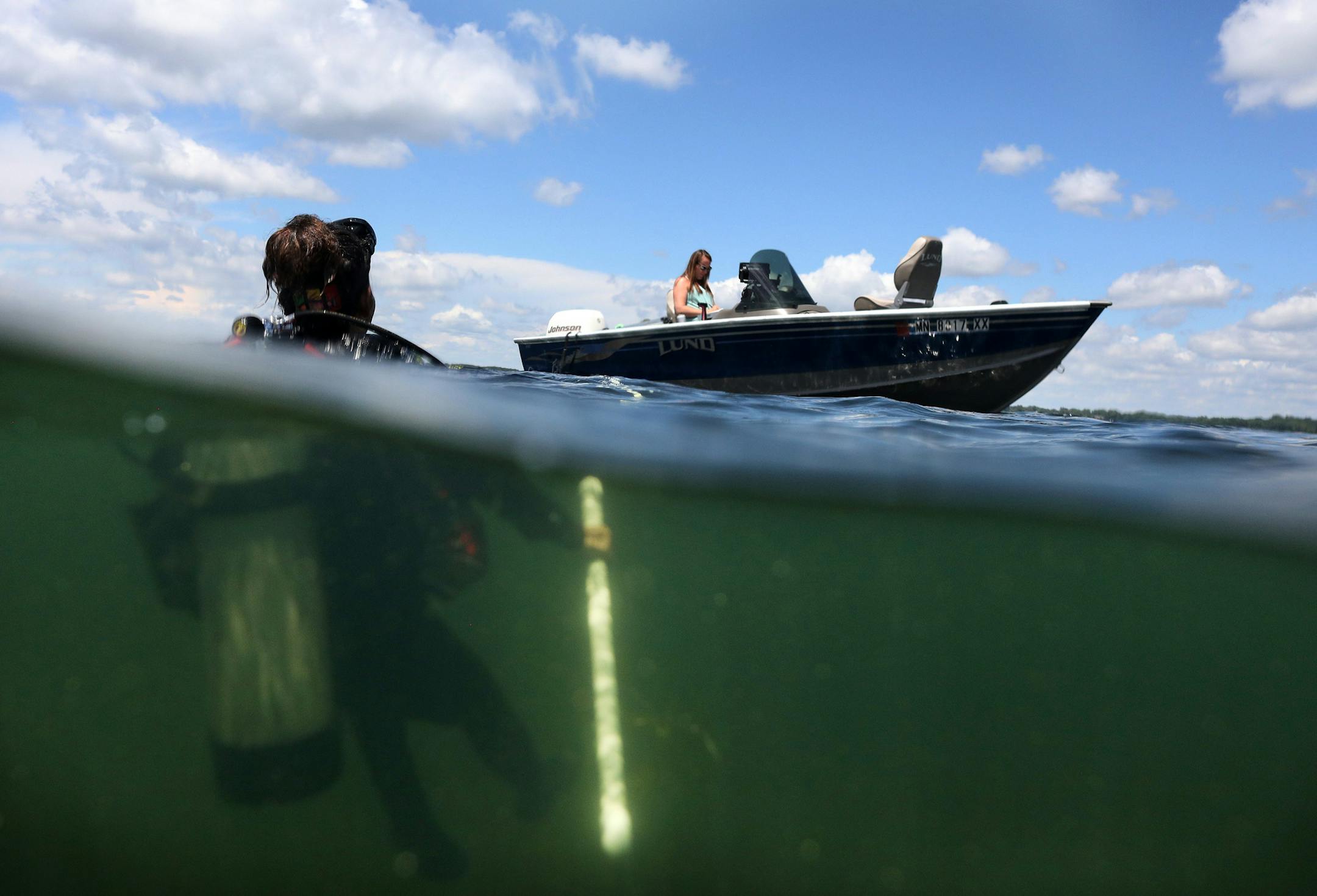 Kylie Cattoor, a Natural Resource Specialist at the Minnesota DNR, looked to her colleague April Londo on the boat after a day of counting zebra mussels for a population study at White Bear Lake. ] ANTHONY SOUFFLE ï anthony.souffle@startribune.com NOTE: Do not use for daily stories. Hold all for Kennedy Zebra Mussels Project. Zebra mussels, an invasive species from eastern Europe, have come to Minnesota. The Star Tribune takes an in-depth look at the zebra mussel issue, its impact, and the