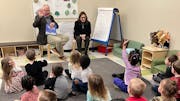 Gov. Tim Walz and Lt. Gov. Peggy Flanagan read to a classroom of children at Tutor Time in Brooklyn Park on Monday, Jan. 22, before announcing a progr