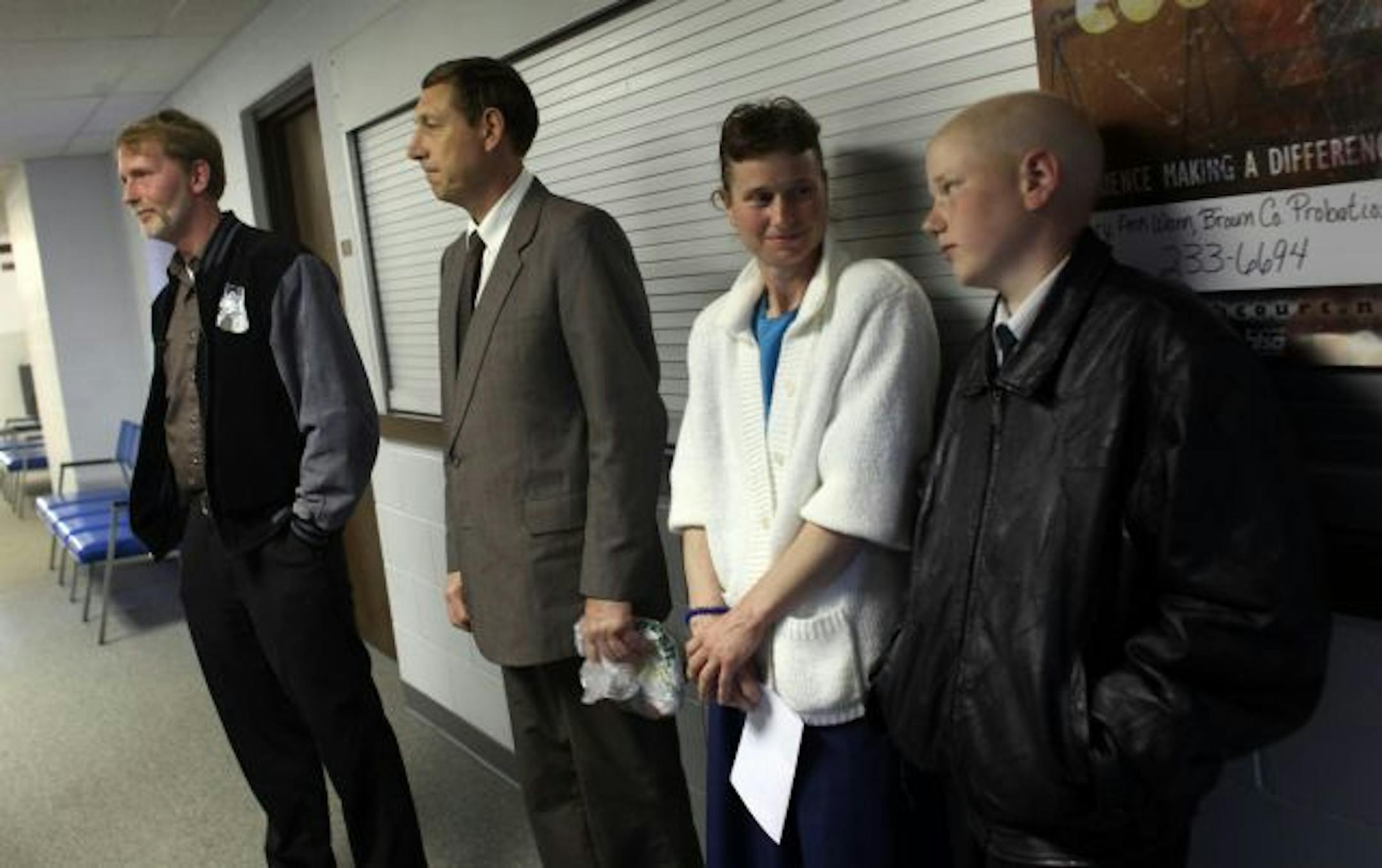 Anthony and Colleen Hauser, with son Danny listen to questions from the media.