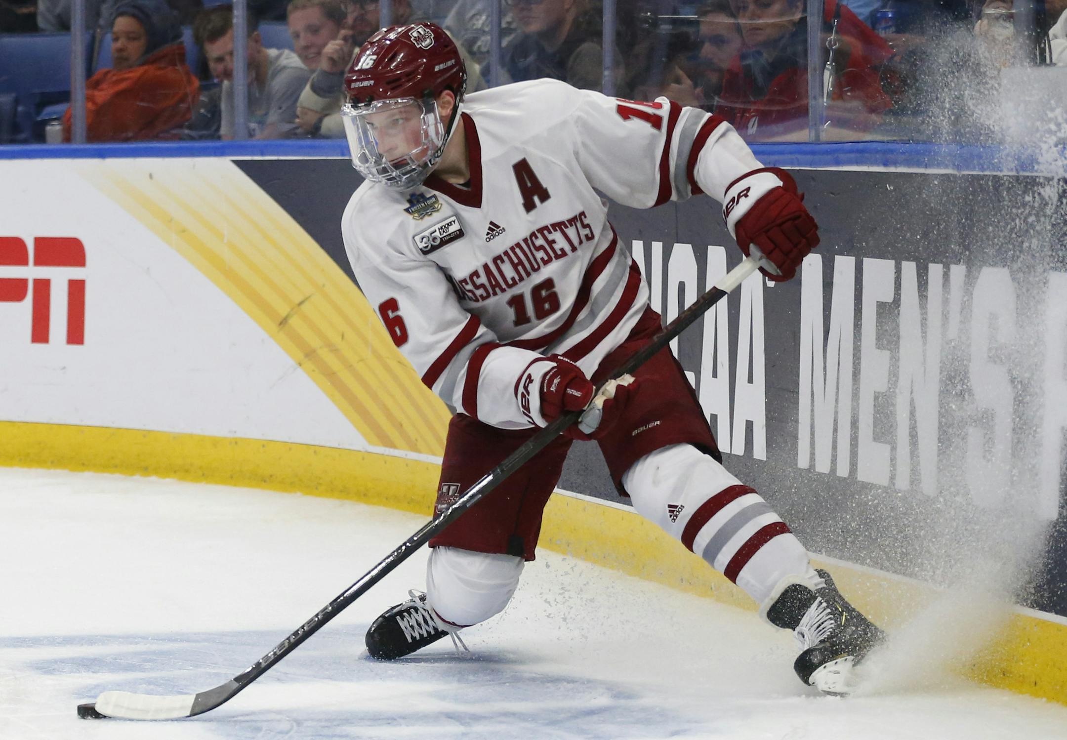 Massachusetts defenseman Cale Makar (16) controls the puck behind the net during the second period of a semifinal of the Frozen Four NCAA men's college hockey tournament against Denver on Thursday, April 11, 2019, in Buffalo, N.Y. (AP Photo/Jeffrey T. Barnes)